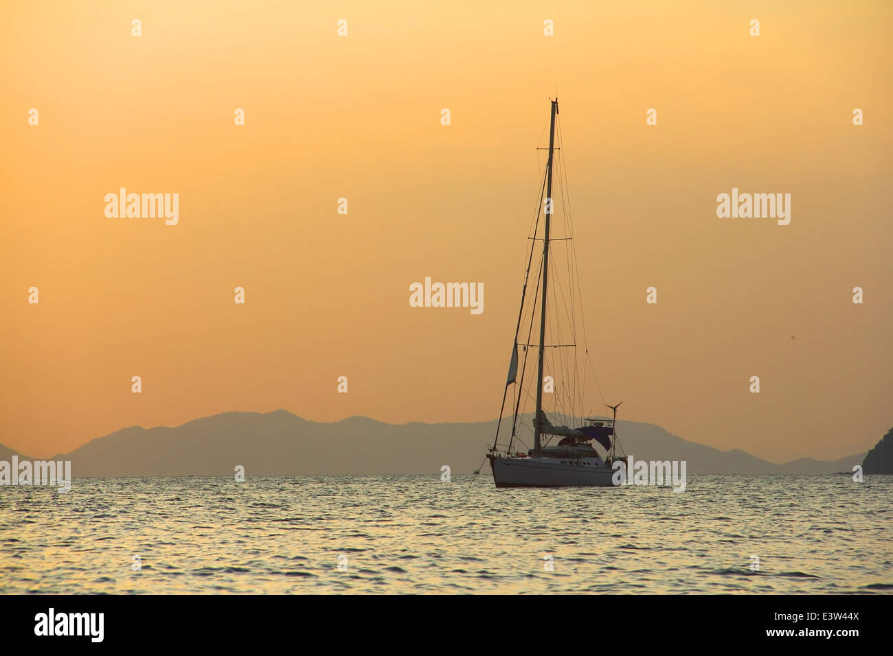 Sailing yaht in open sea on beautiful sunset sky background Stock Photo ...