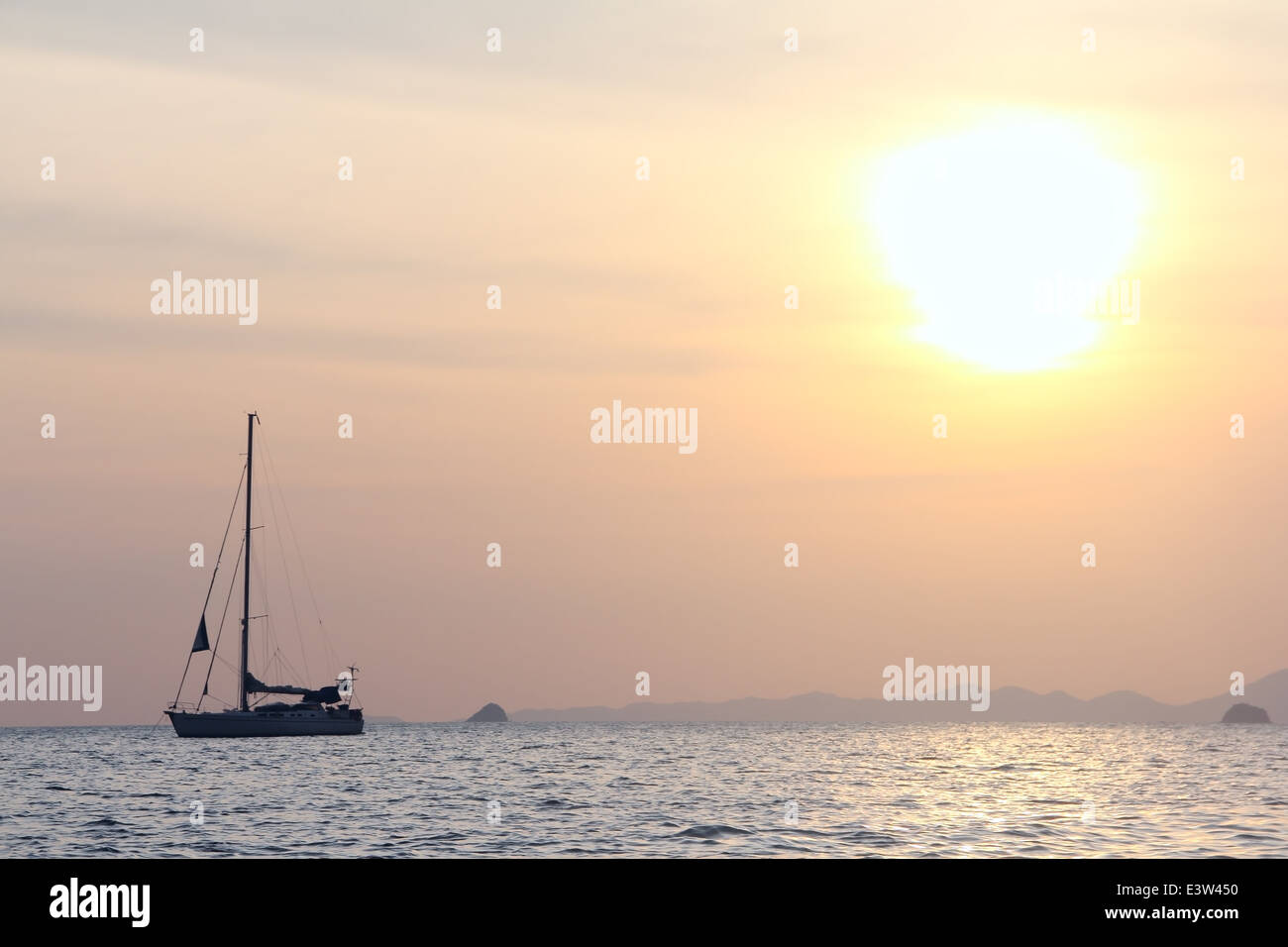 Sailing yaht in open sea on beautiful sunset sky background Stock Photo ...