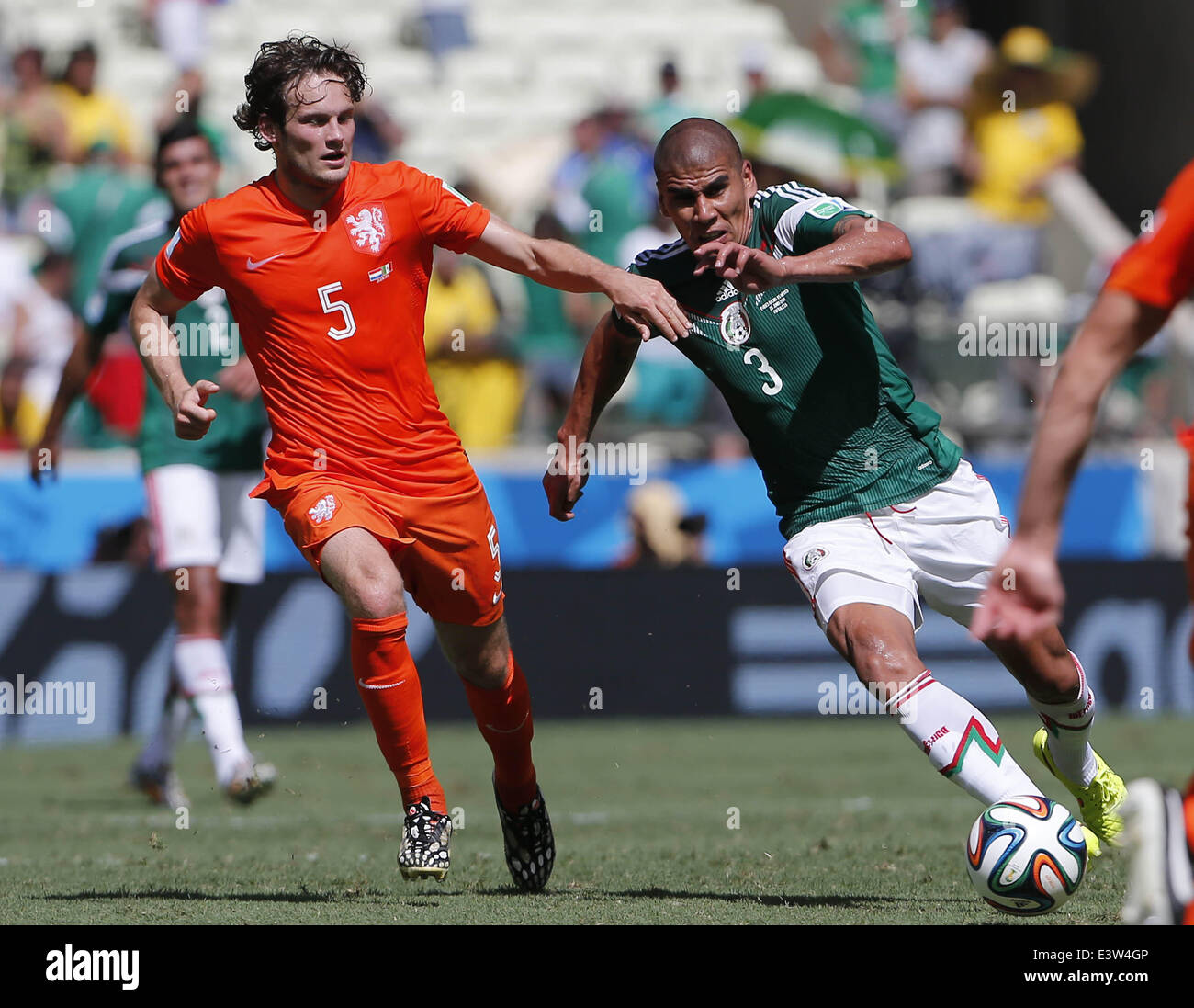 Fortaleza, Brazil. 29th June, 2014. Mexico's Carlos Salcido vies with Netherlands's Daley Blind during a Round of 16 match between Netherlands and Mexico of 2014 FIFA World Cup at the Estadio Castelao Stadium in Fortaleza, Brazil, on June 29, 2014. Credit:  Zhou Lei/Xinhua/Alamy Live News Stock Photo