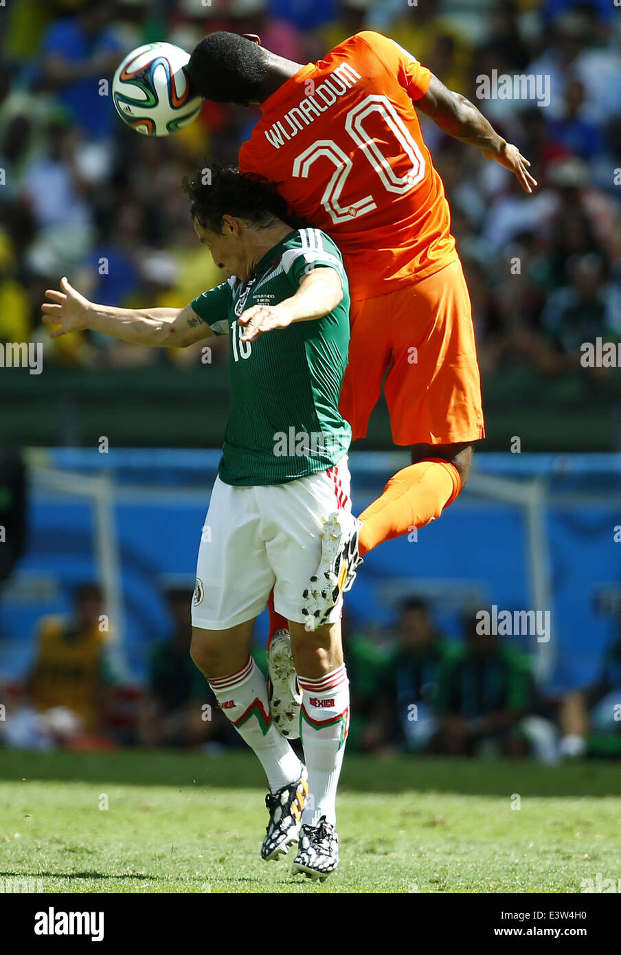Fortaleza, Brazil. 29th June, 2014. Netherlands's Georginio Wijnaldum (R) competes for a header with Mexico's Andres Guardado during a Round of 16 match between Netherlands and Mexico of 2014 FIFA World Cup at the Estadio Castelao Stadium in Fortaleza, Brazil, on June 29, 2014. Credit:  Chen Jianli/Xinhua/Alamy Live News Stock Photo