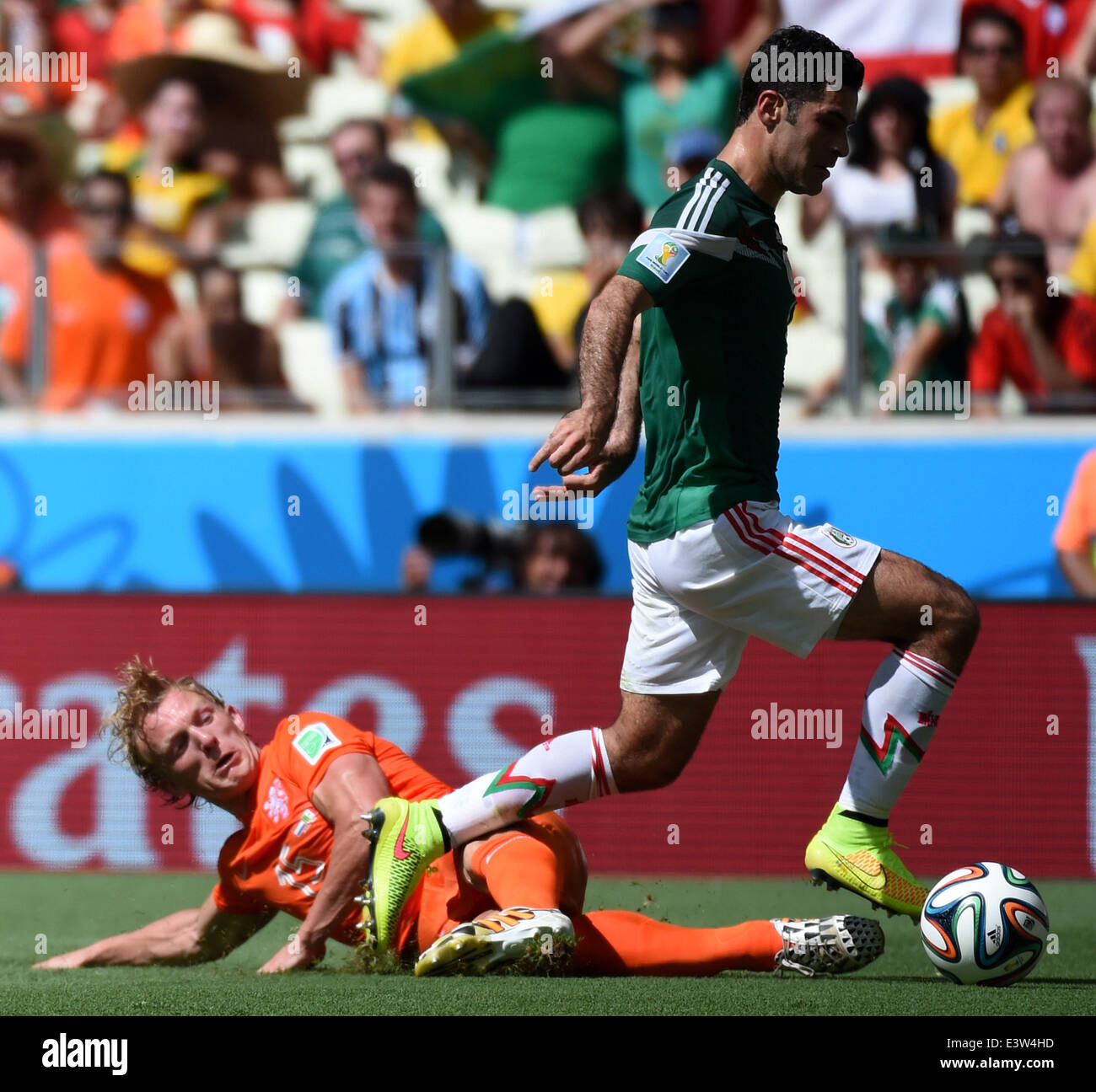 Fortaleza, Brazil. 29th June, 2014. Netherlands's Dirk Kuyt (L) vies with Mexico's Rafael Marquez during a Round of 16 match between Netherlands and Mexico of 2014 FIFA World Cup at the Estadio Castelao Stadium in Fortaleza, Brazil, on June 29, 2014. Credit:  Li Ga/Xinhua/Alamy Live News Stock Photo
