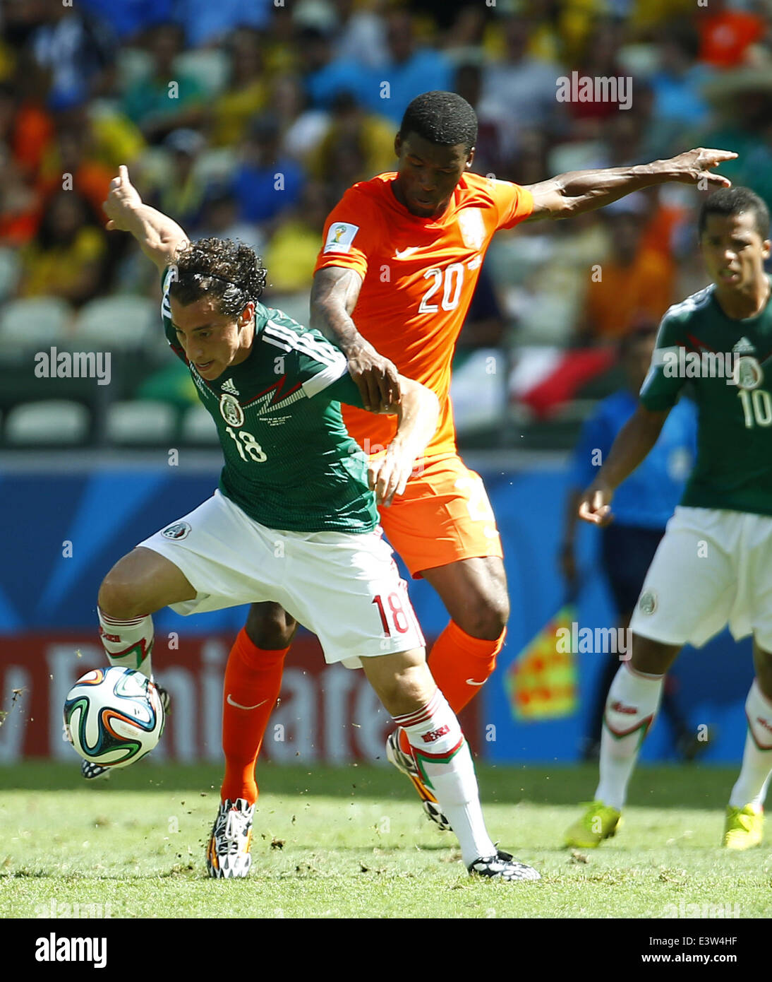 Fortaleza, Brazil. 29th June, 2014. Netherlands's Georginio Wijnaldum (R) vies with Mexico's Andres Guardado during a Round of 16 match between Netherlands and Mexico of 2014 FIFA World Cup at the Estadio Castelao Stadium in Fortaleza, Brazil, on June 29, 2014. Credit:  Chen Jianli/Xinhua/Alamy Live News Stock Photo