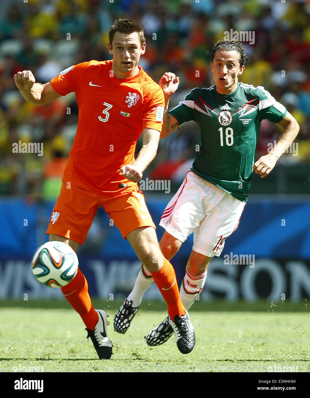 Fortaleza, Brazil. 29th June, 2014. Netherlands's Stefan de Vrij (L) vies with Mexico's Andres Guardado during a Round of 16 match between Netherlands and Mexico of 2014 FIFA World Cup at the Estadio Castelao Stadium in Fortaleza, Brazil, on June 29, 2014. Credit:  Chen Jianli/Xinhua/Alamy Live News Stock Photo