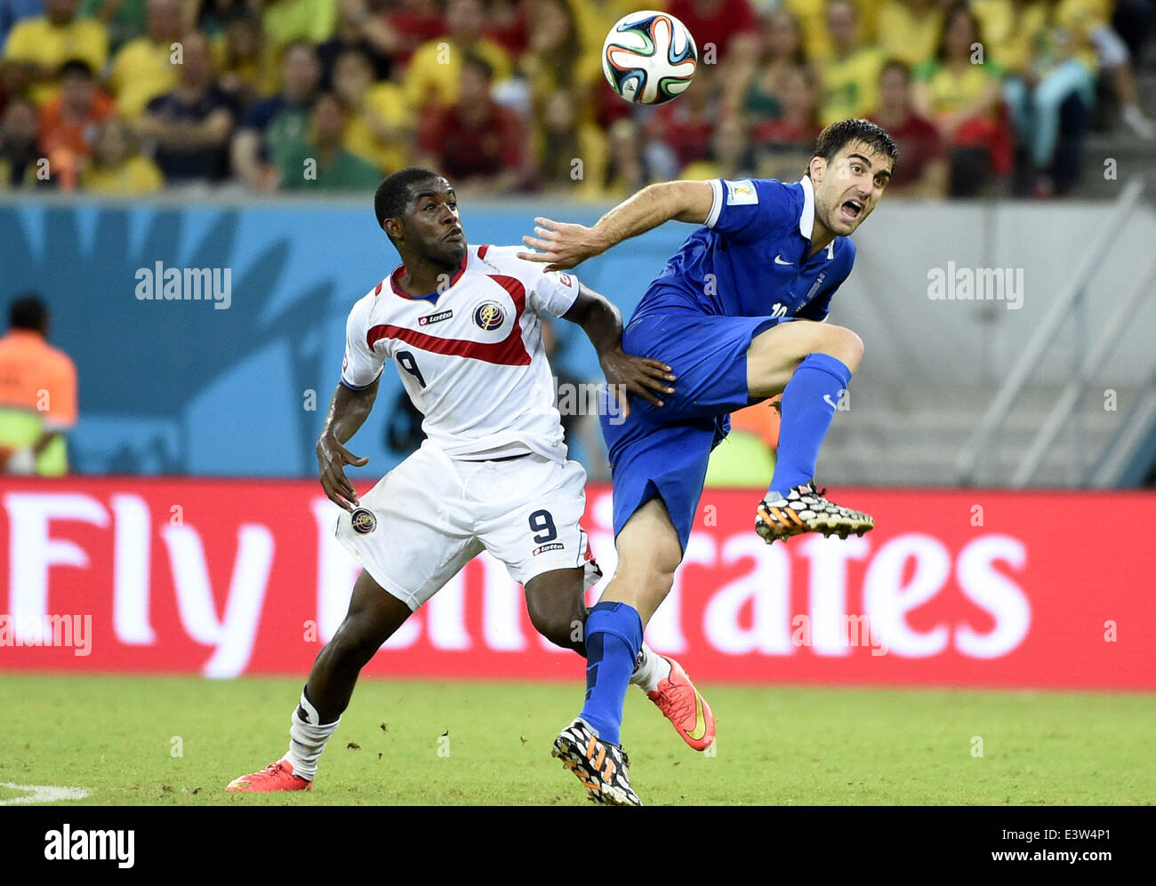 (140629) -- RECIFE, June 29, 2014 (Xinhua) -- Costa Rica's Joel Campbell (L) vies with Greece's Sokratis Papastathopoulos during a Round of 16 match between Costa Rica and Greece of 2014 FIFA World Cup at the Arena Pernambuco Stadium in Recife, Brazil, on June 29, 2014.(Xinhua/Lui Siu Wai)(pcy) Stock Photo