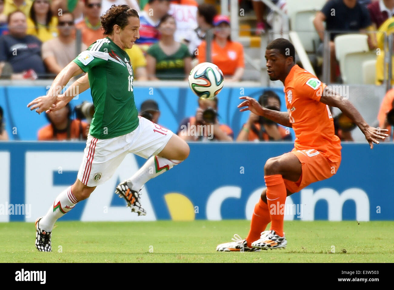 Fortaleza, Brazil. 29th June, 2014. Netherlands's Georginio Wijnaldum (R) vies with Mexico's Andres Guardado during a Round of 16 match between Netherlands and Mexico of 2014 FIFA World Cup at the Estadio Castelao Stadium in Fortaleza, Brazil, on June 29, 2014. Credit:  Li Ga/Xinhua/Alamy Live News Stock Photo