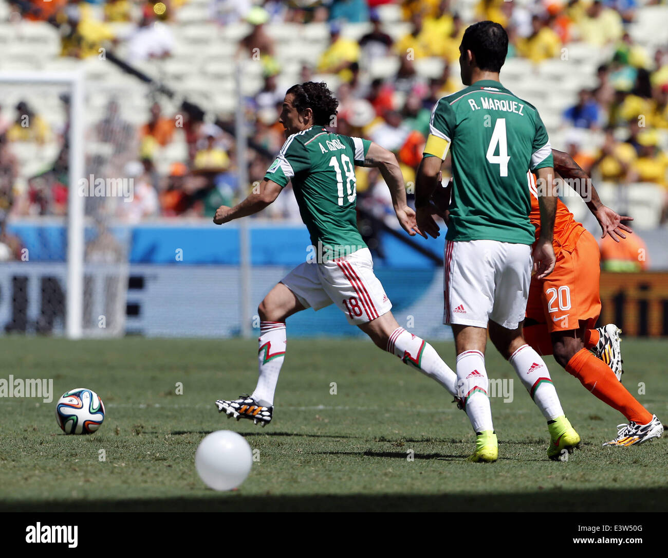 Fortaleza, Brazil. 29th June, 2014. Mexico's Andres Guardado (1st L) controls the ball during a Round of 16 match between Netherlands and Mexico of 2014 FIFA World Cup at the Estadio Castelao Stadium in Fortaleza, Brazil, on June 29, 2014. Credit:  Zhou Lei/Xinhua/Alamy Live News Stock Photo