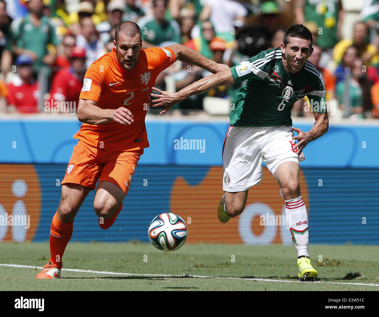 Fortaleza, Brazil. 29th June, 2014. Mexico's Hector Herrera vies with Netherlands's Ron Vlaar during a Round of 16 match between Netherlands and Mexico of 2014 FIFA World Cup at the Estadio Castelao Stadium in Fortaleza, Brazil, on June 29, 2014. Credit:  Zhou Lei/Xinhua/Alamy Live News Stock Photo