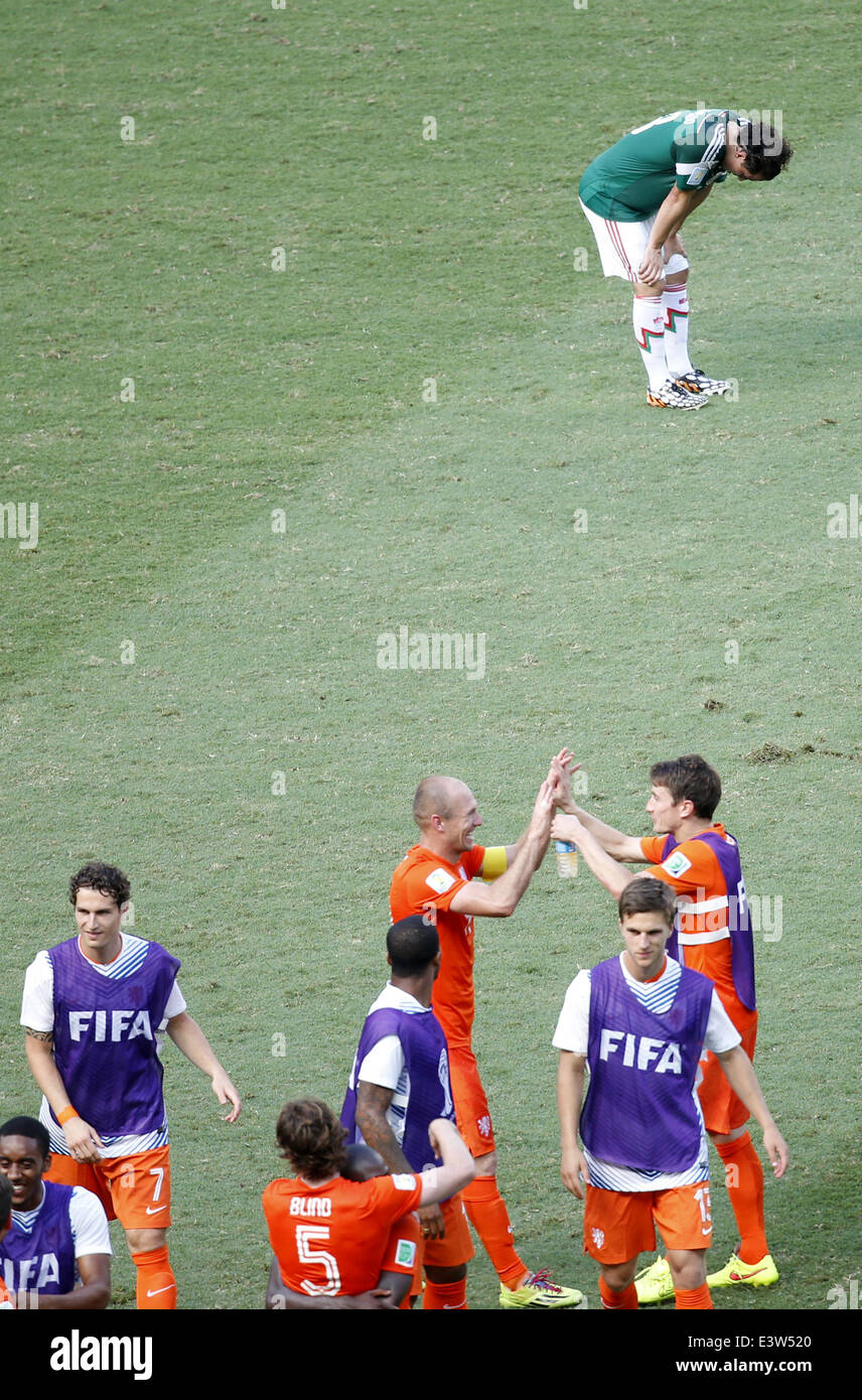 Fortaleza, Brazil. 29th June, 2014. Mexico's Andres Guardado (back) reacts while Netherlands' players celebrate the victory after a Round of 16 match between Netherlands and Mexico of 2014 FIFA World Cup at the Estadio Castelao Stadium in Fortaleza, Brazil, on June 29, 2014. Netherlands won 2-1 over Mexico and qualified for Quarter-finals on Sunday. Credit:  Liao Yujie/Xinhua/Alamy Live News Stock Photo