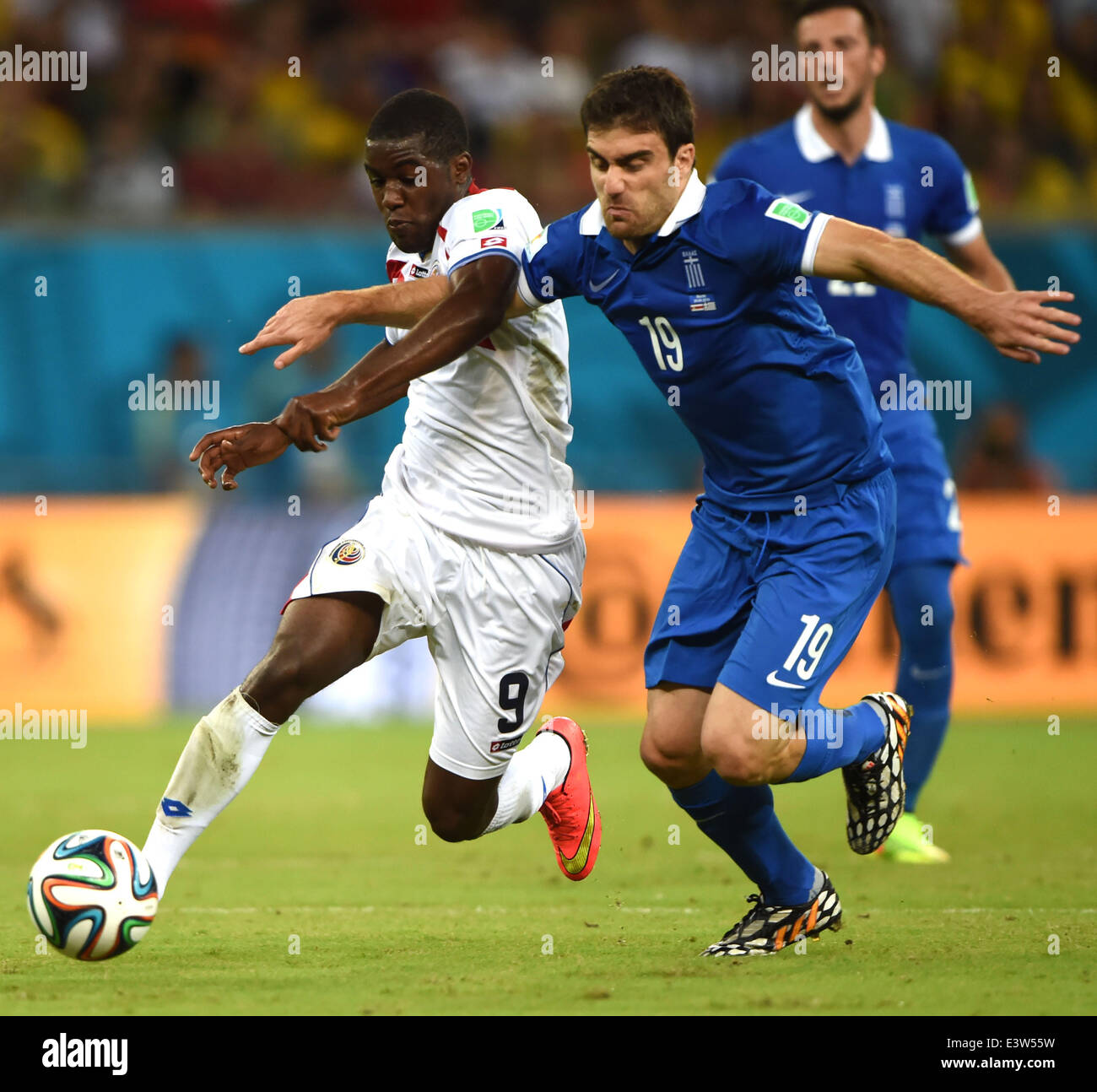 Recife, Brazil. 29th June, 2014. Costa Rica's Joel Campbell vies with Greece's Sokratis Papastathopoulos during a Round of 16 match between Costa Rica and Greece of 2014 FIFA World Cup at the Arena Pernambuco Stadium in Recife, Brazil, on June 29, 2014. Credit:  Guo Yong/Xinhua/Alamy Live News Stock Photo