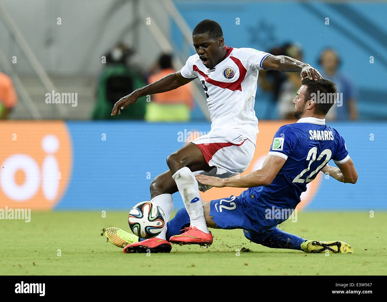 Recife, Brazil. 29th June, 2014. Costa Rica's Joel Campbell (top) vies with Greece's Andreas Samaris during a Round of 16 match between Costa Rica and Greece of 2014 FIFA World Cup at the Arena Pernambuco Stadium in Recife, Brazil, on June 29, 2014. Credit:  Yang Lei/Xinhua/Alamy Live News Stock Photo