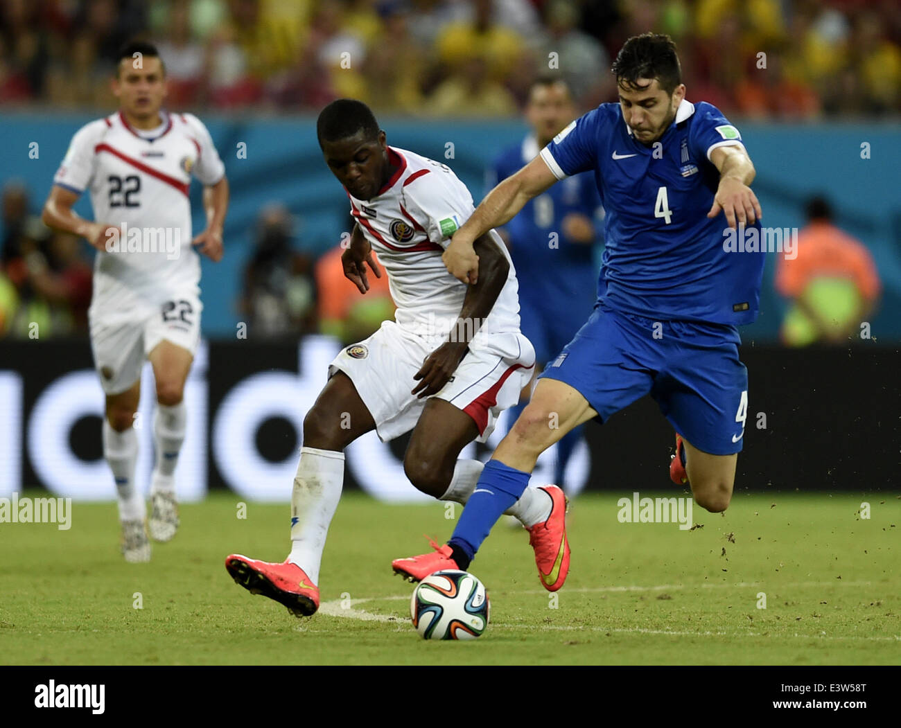 Recife, Brazil. 29th June, 2014. Greece's Kostas Manolas (R, front) competes with Costa Rica's Joel Campbell during a Round of 16 match between Costa Rica and Greece of 2014 FIFA World Cup at the Arena Pernambuco Stadium in Recife, Brazil, on June 29, 2014. Credit:  Yang Lei/Xinhua/Alamy Live News Stock Photo