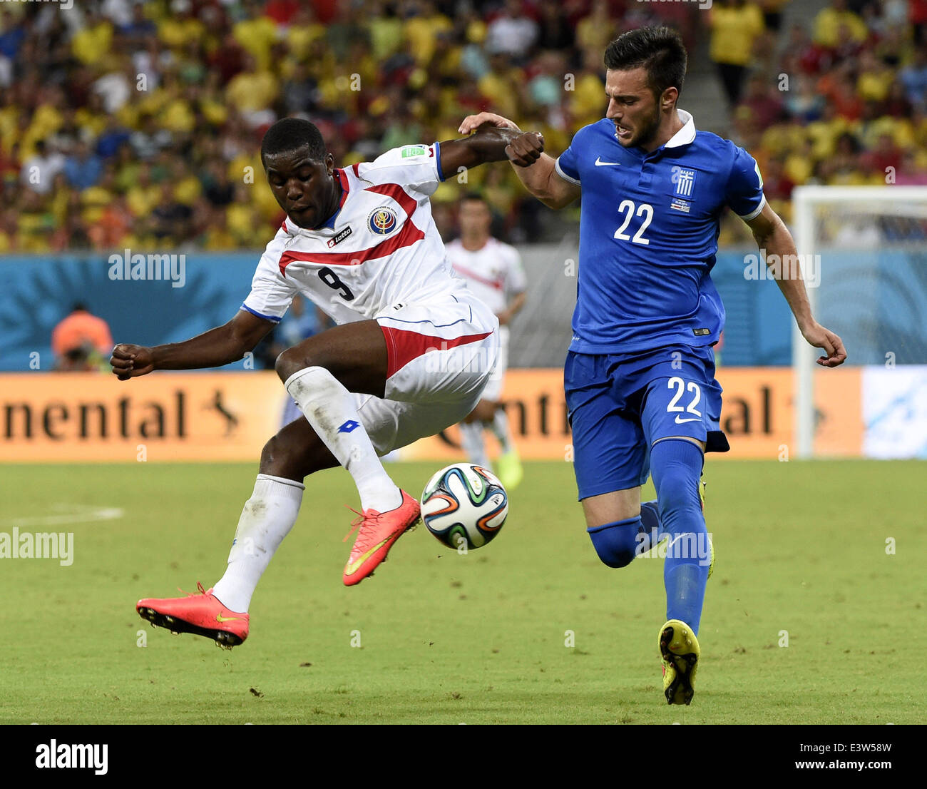 Recife, Brazil. 29th June, 2014. Costa Rica's Joel Campbell (L) vies with Greece's Andreas Samaris during a Round of 16 match between Costa Rica and Greece of 2014 FIFA World Cup at the Arena Pernambuco Stadium in Recife, Brazil, on June 29, 2014. Credit:  Lui Siu Wai/Xinhua/Alamy Live News Stock Photo
