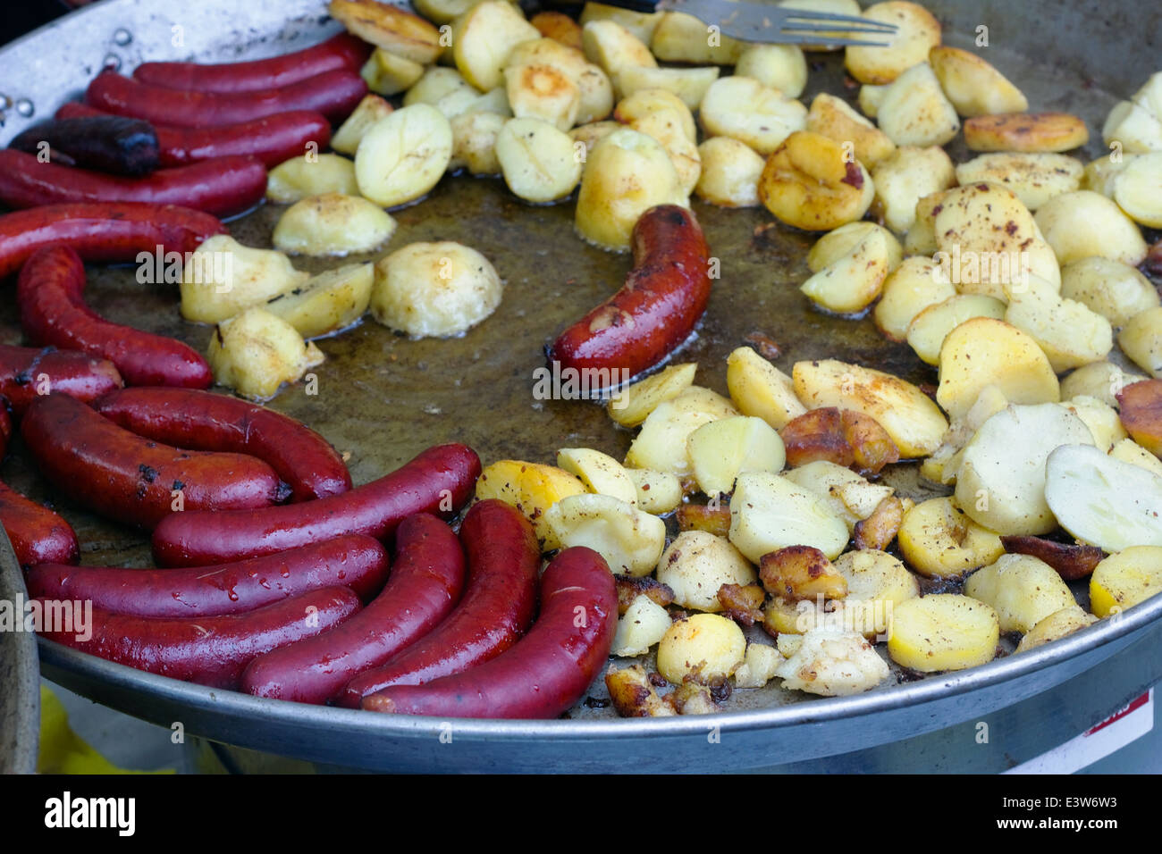Street food smoked sausage and potatoes fried in lard. Selective art