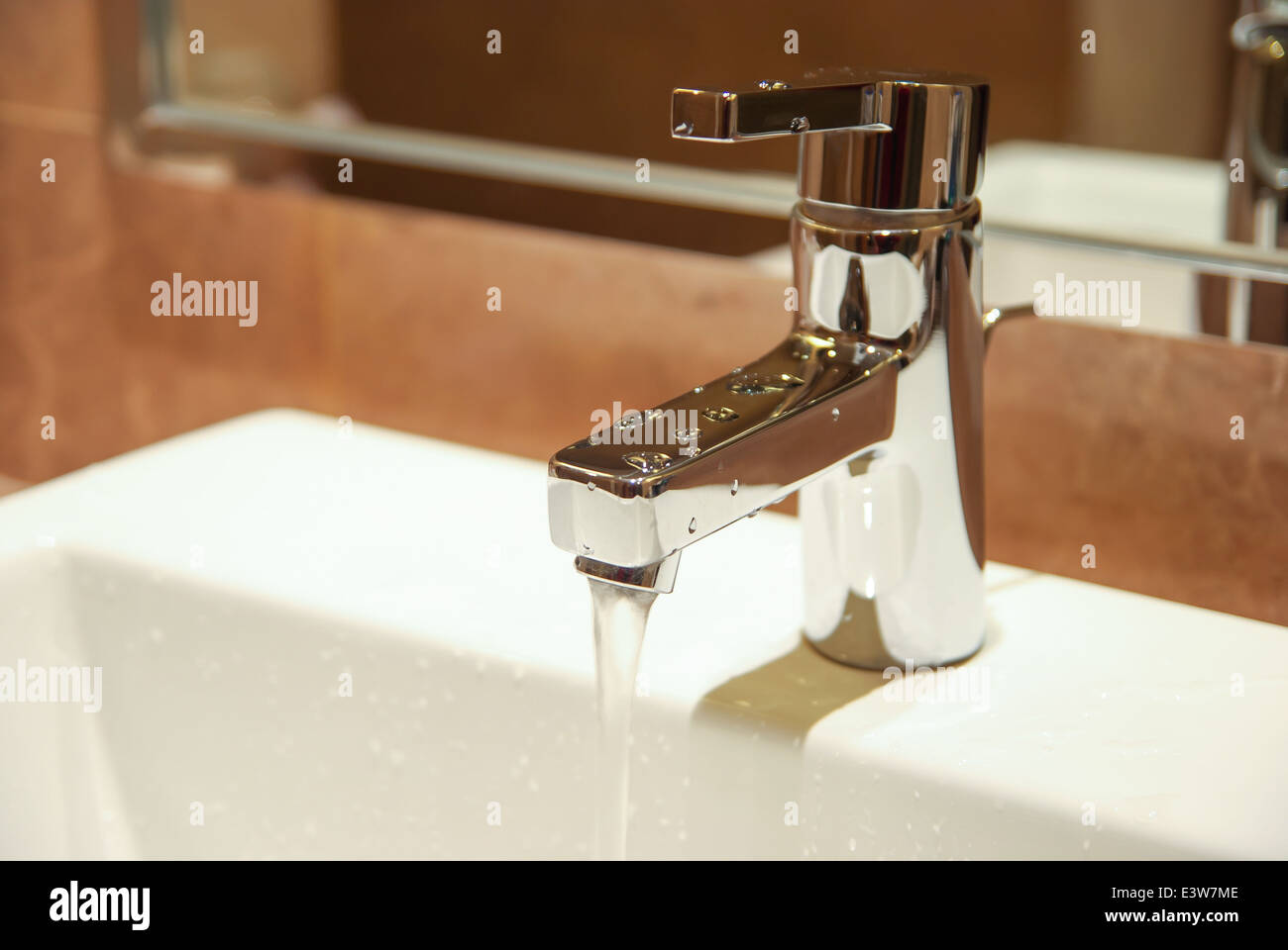 stainless steel water tap in a bath room Stock Photo