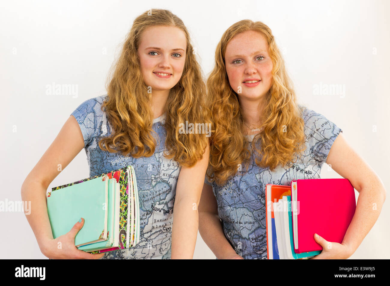 Schoolgirls carrying textbooks Stock Photo