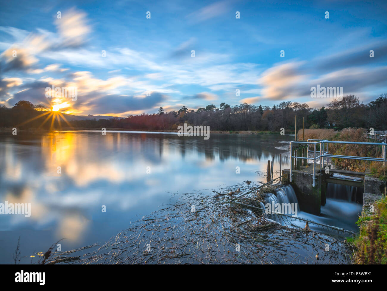 Sunset with clouds at Burton Mill Pond, West Sussex, UK Stock Photo