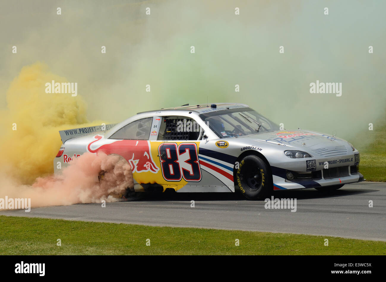 The Goodwood Festival of Speed. Toyota Camry race car burning rubber with multi coloured smoke Stock Photo