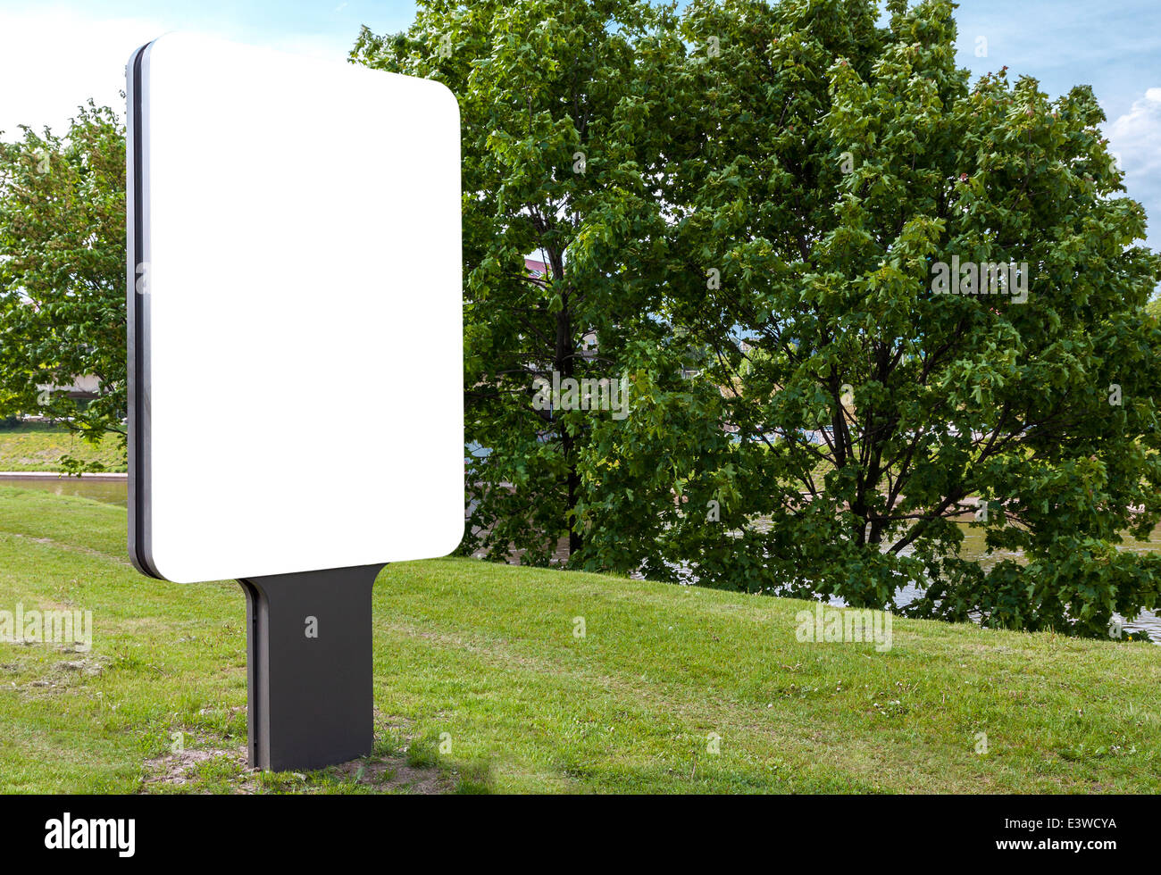 White blank billboard against green trees Stock Photo - Alamy