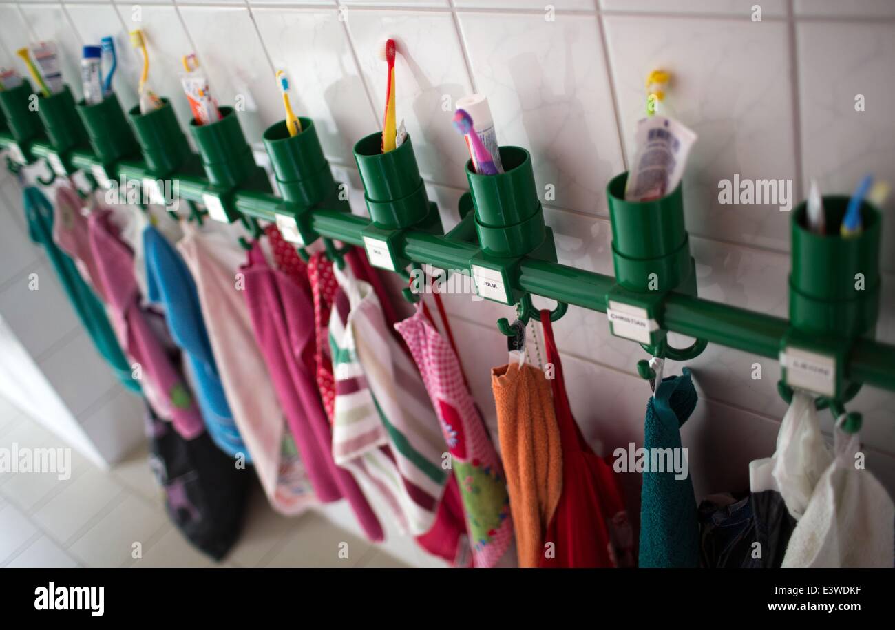 Wismar, Germany. 19th June, 2014. Colourful towels and toothbrush tumblers stand on a shelf in the washing room of the integrated nursery 'Plappersnut' in Wismar, Germany, 19 June 2014. The intergrated nursery 'Plappersnut' accommodates up to 180 children in 12 groups and provides special support for children with special needs, offering amongst many other things, an array of activities such as wood and pottery workshops, childrens' kitchen and cooking sessions and special facilities for therapeutic requirements. Photo: Jens Buettner/dpa/Alamy Live News Stock Photo