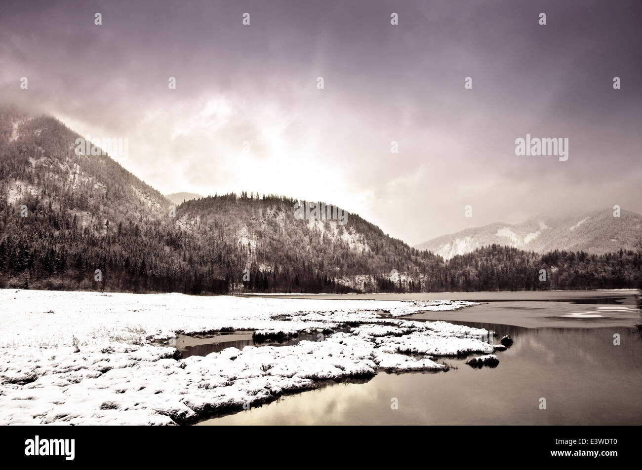 Winterly landscape in the mountains with dramatic sky Stock Photo