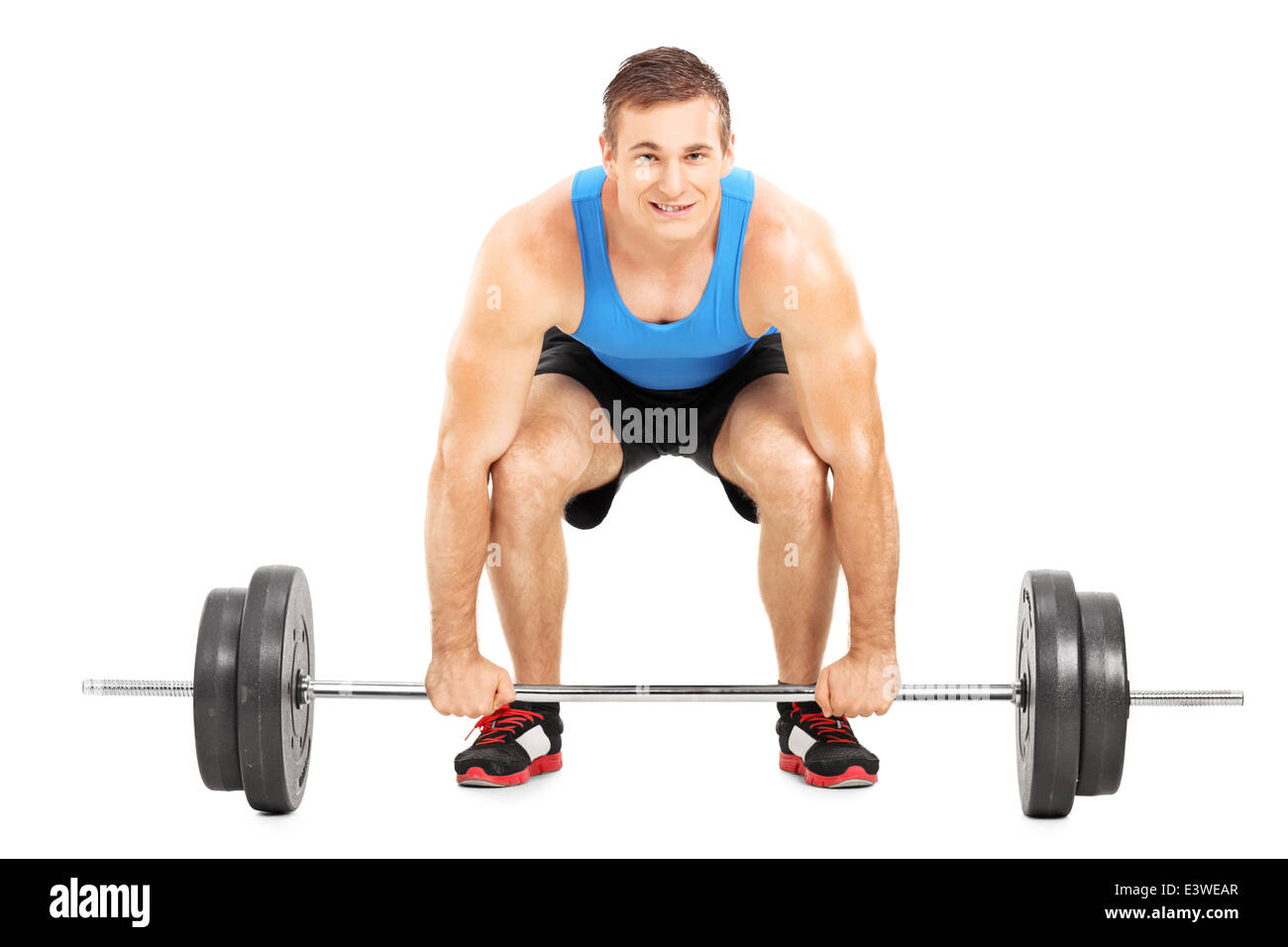 Weightlifting athlete lifting a barbell Stock Photo