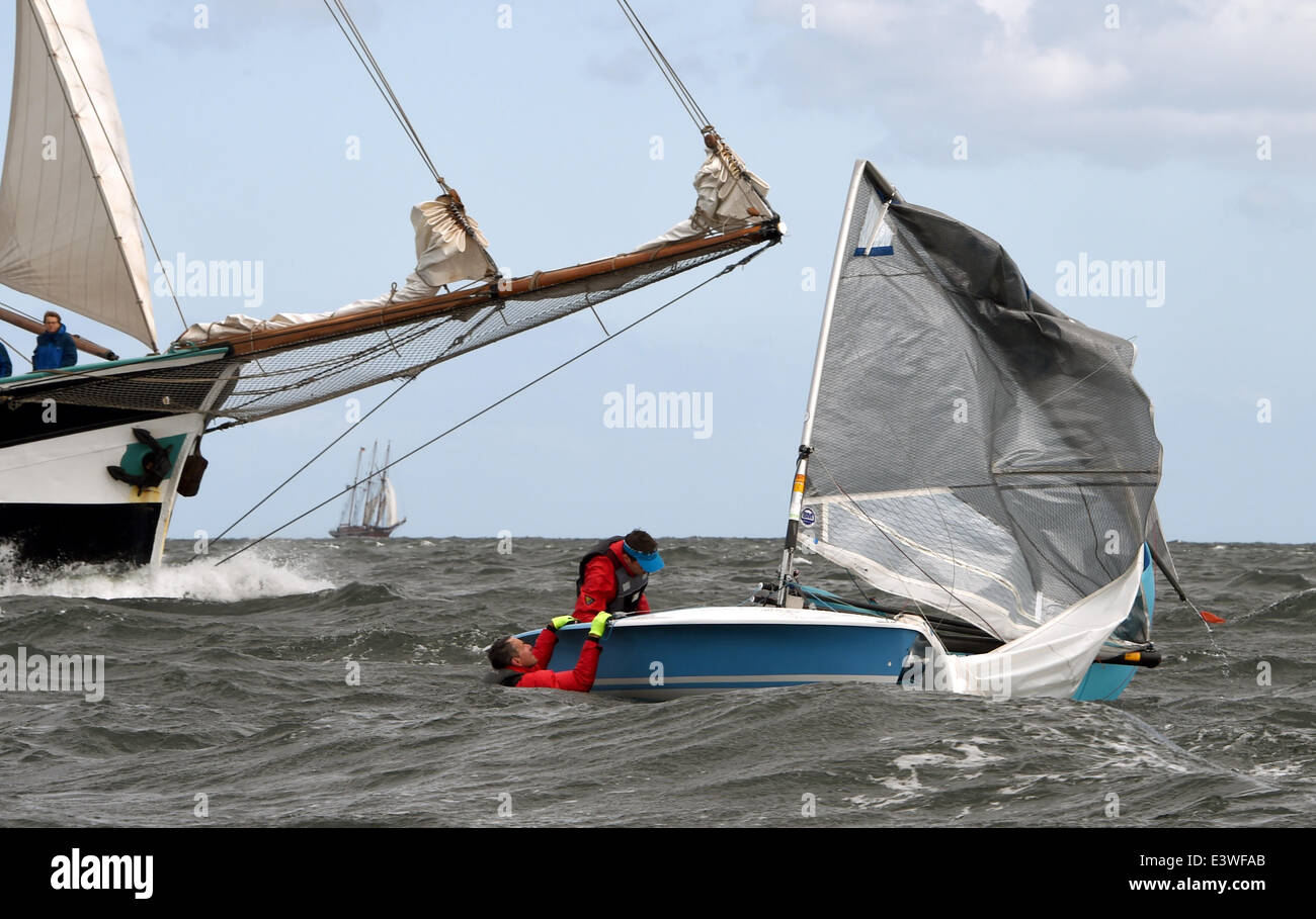 German sailing team Lutz Kandzia and John Christiansen have capsized with their 505 dinghy off Kiel-Schilksee, Germany, 22 June 2014. Stron winds led to cancellation of almost all regattas during Kiel Week. Photo: Carsten Rehder/dpa Stock Photo