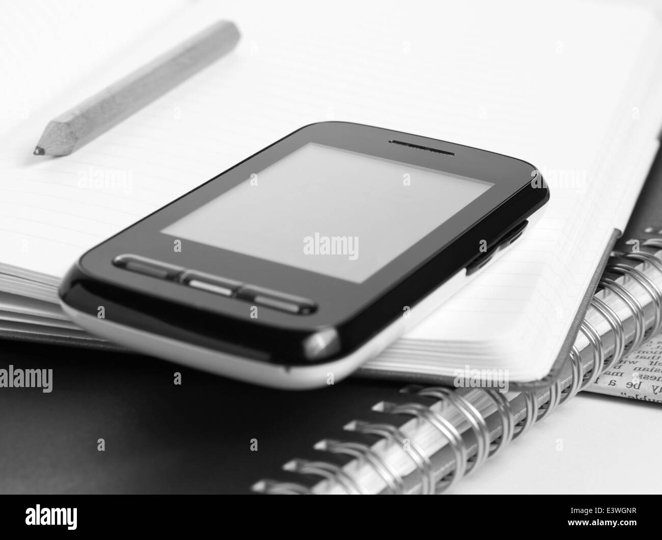 smart phone with touch screen on the open notepad Stock Photo