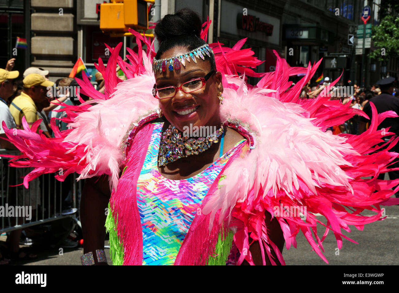 NYC: Woman with spectacular pink feather boa wrap at the 2014 Gay Pride Parade on Fifth Avenue Stock Photo