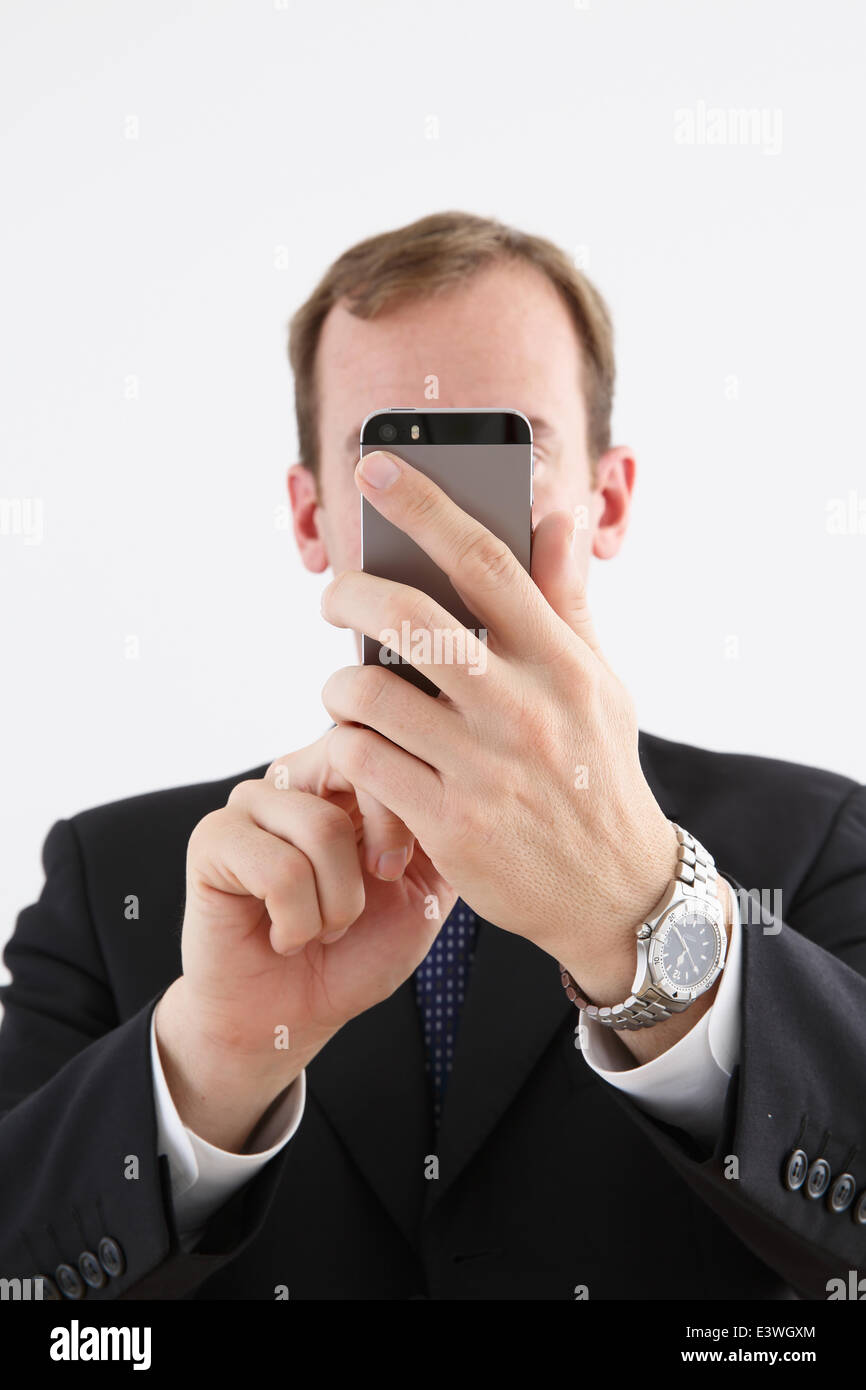 Businessman in a suit with smartphone Stock Photo - Alamy