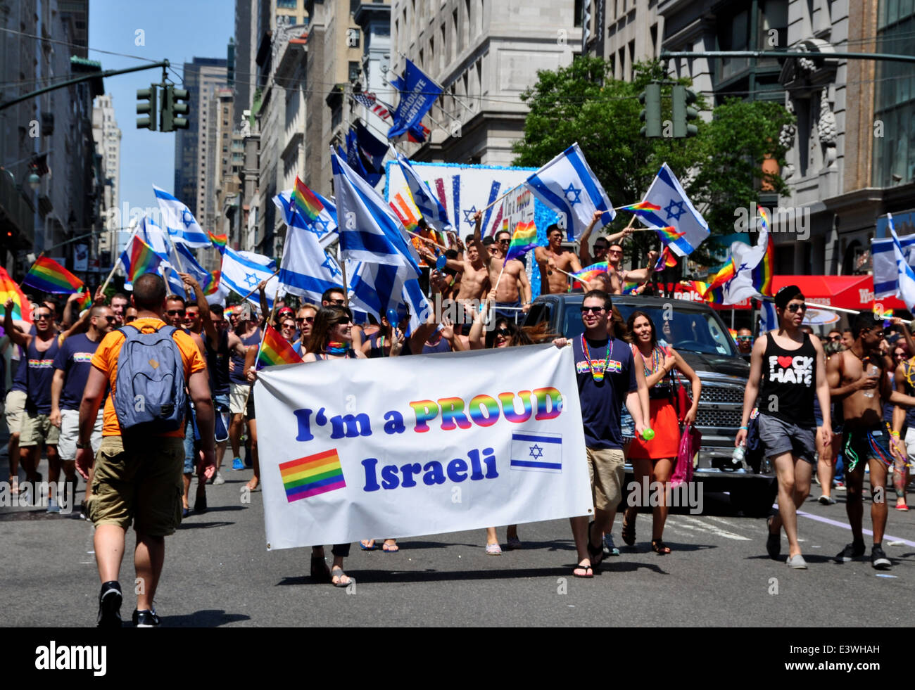 NYC: Proud gay Israelis with their banner and waving the flag of Israel at the 2014 Gay Pride Parade on Fifth Avenue Stock Photo