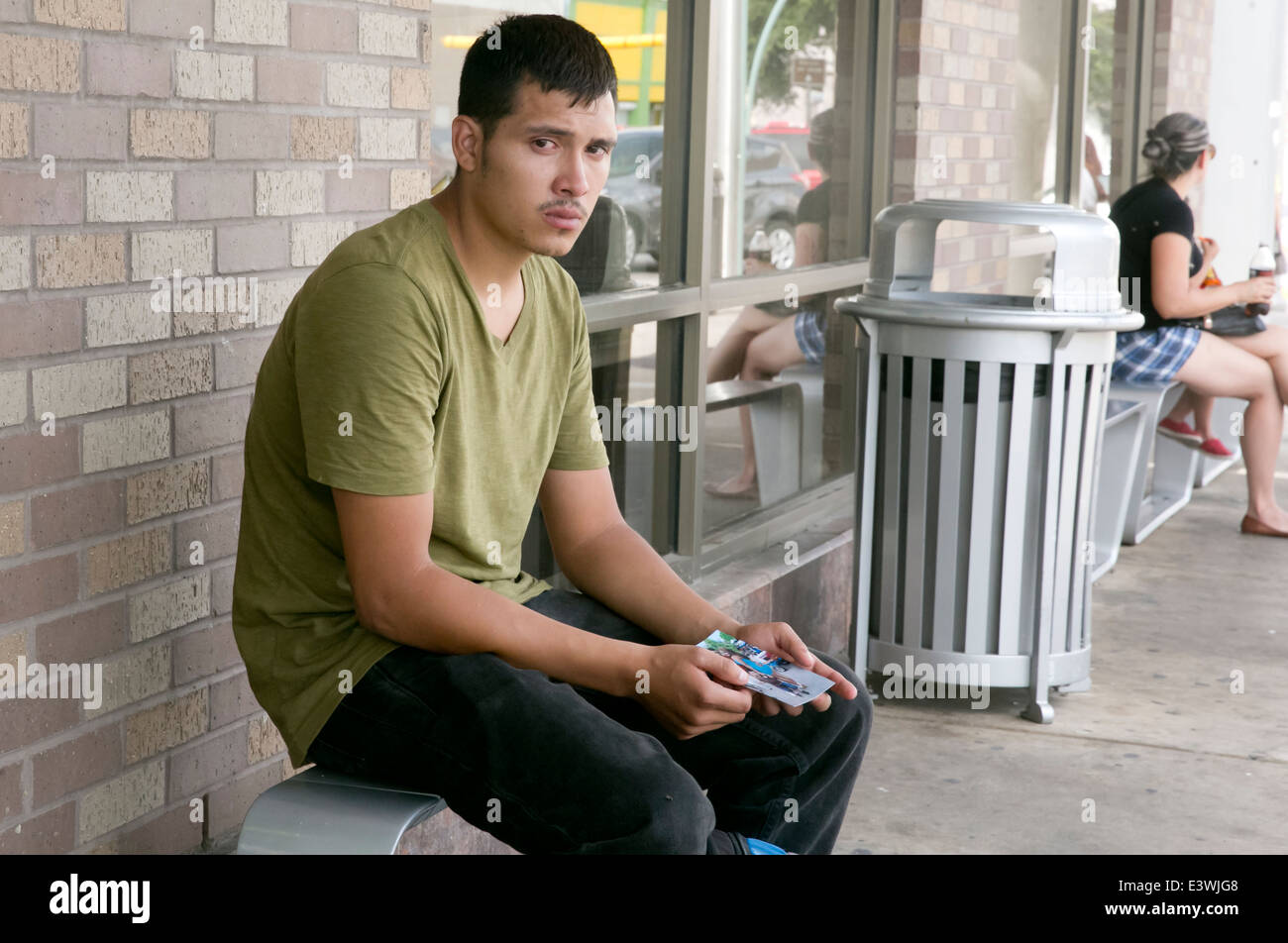 Male US citizen at McAllen, Texas bus station tries to get info on whereabouts of common law wife and child illegally brought Stock Photo