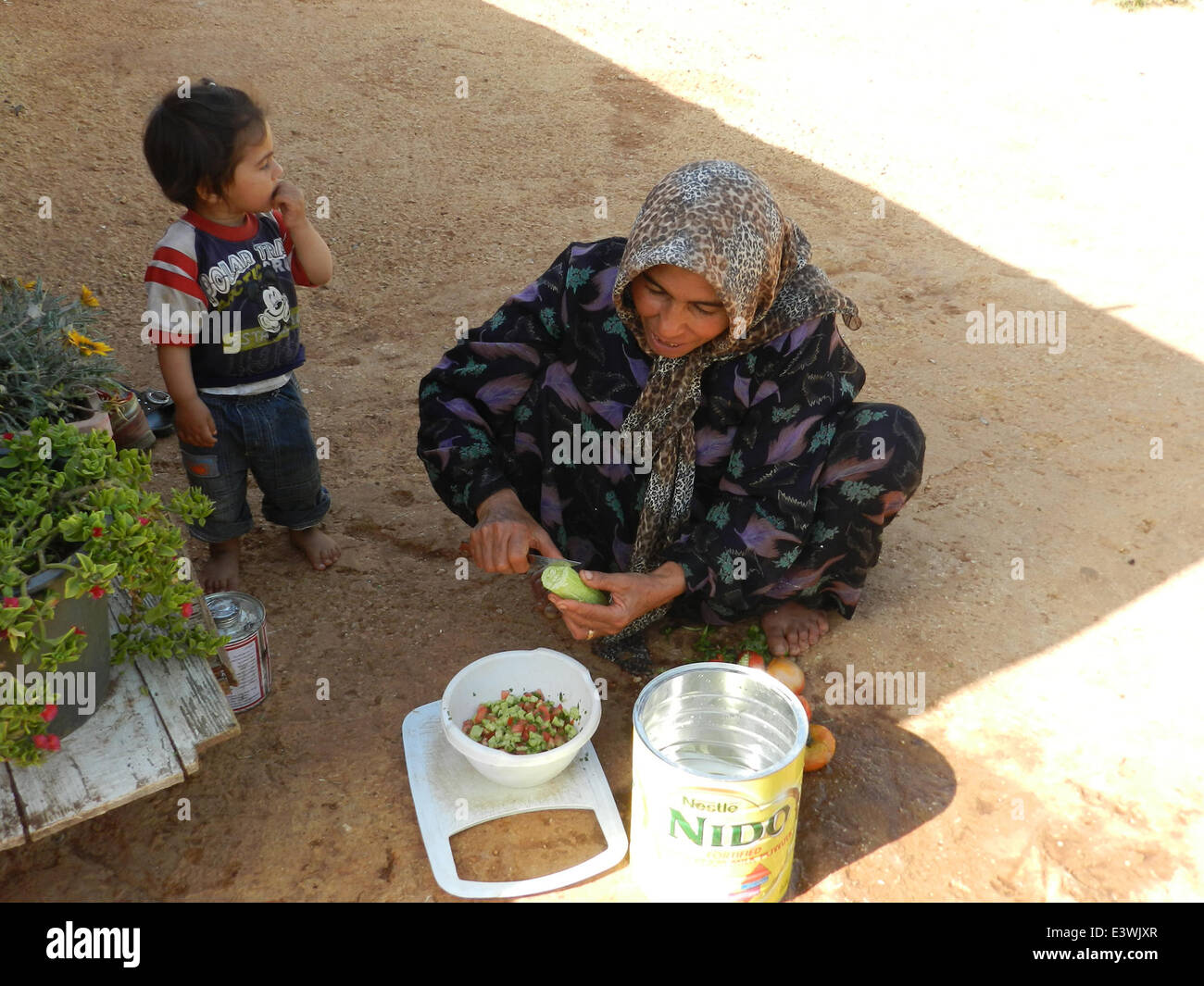 Beirut. 29th June, 2014. A Syrian refugee cooks Iftar food on the first ...