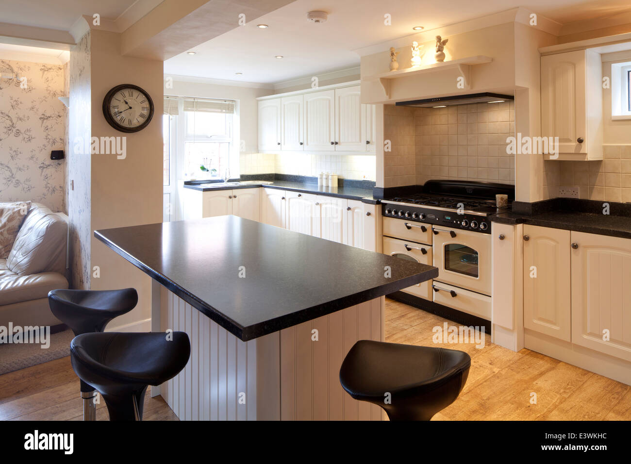 Bar Stools At Breakfast Bar In Modern Country Style Kitchen Stock