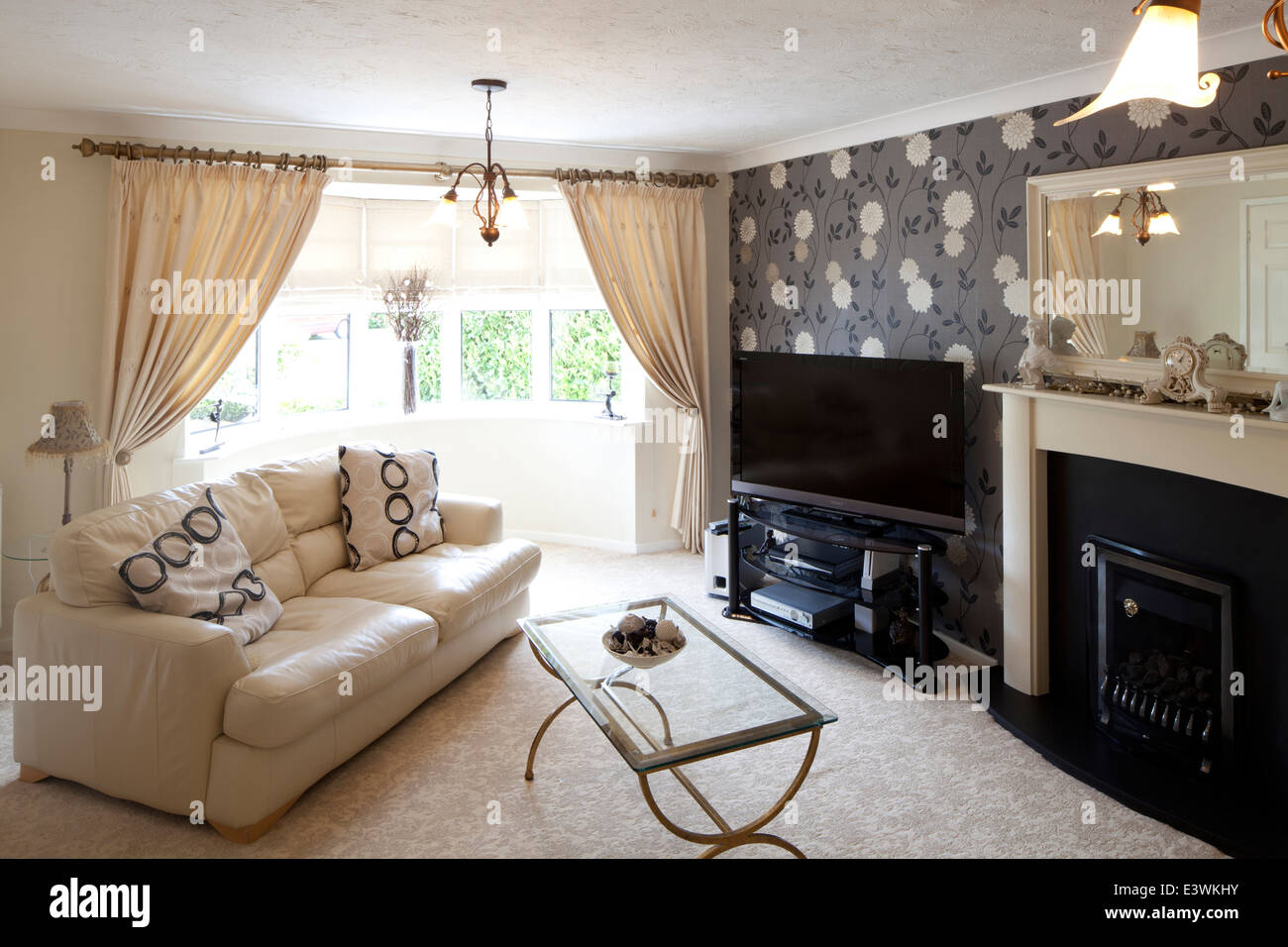 Sofa facing fireplace in sitting room, Cheshire, UK Stock Photo