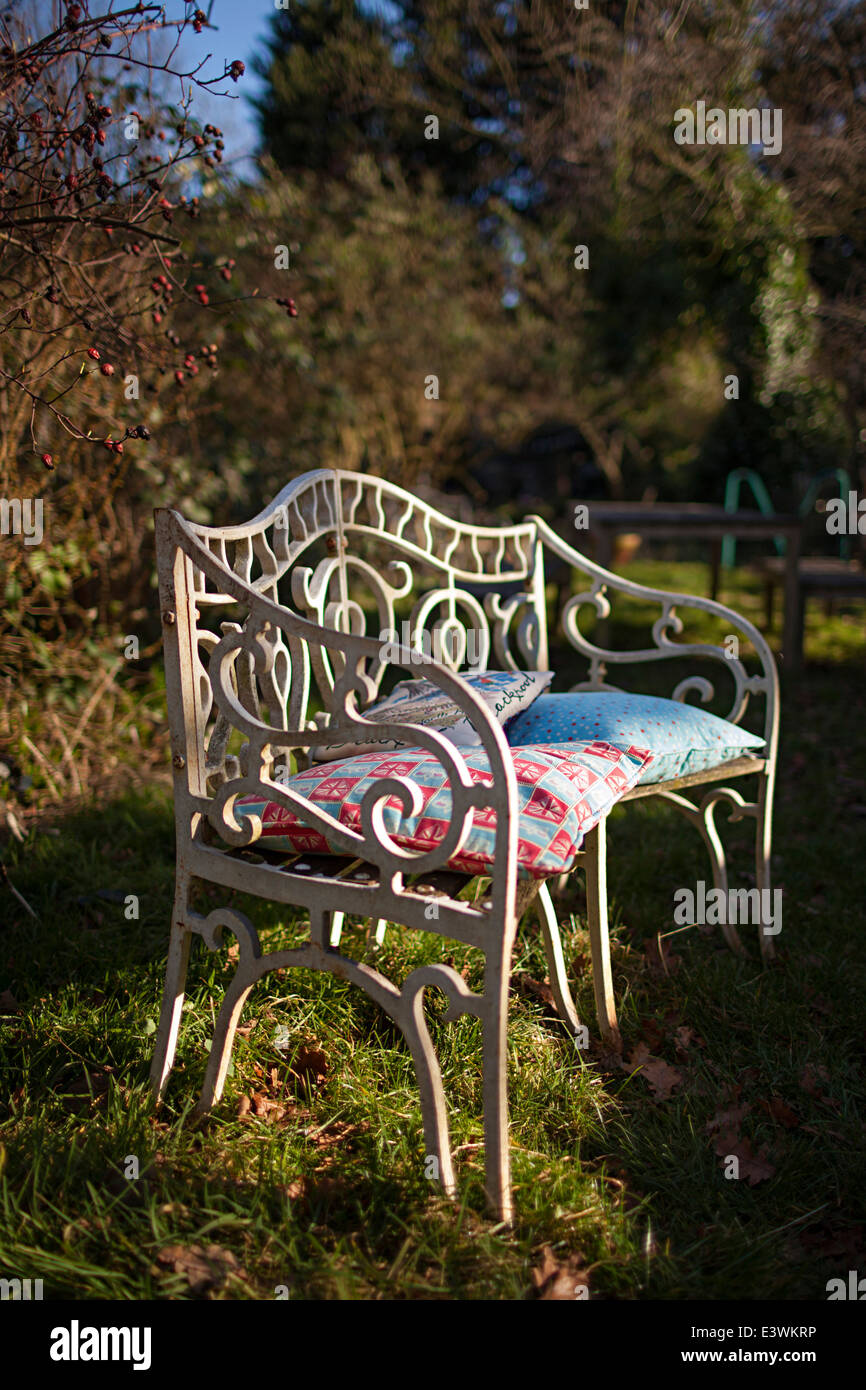 Wrought Iron Bench In The Garden With Cushions At The Home Of Miss