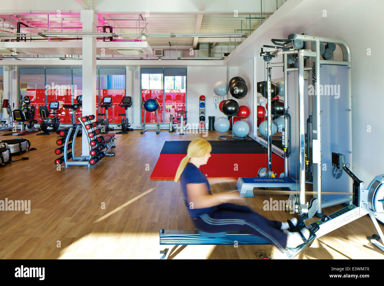 Woman using rowing machine in the Central Leisure Centre, Rochdale, Greater Manchester, UK Stock Photo