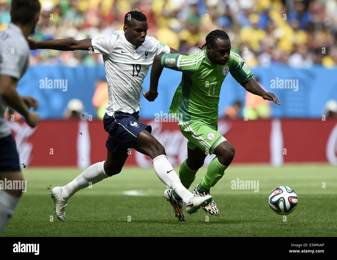 Brasilia, Brazil. 30th June, 2014. France's Paul Pogba vies with Nigeria's Victor Moses during a Round of 16 match between France and Nigeria of 2014 FIFA World Cup at the Estadio Nacional Stadium in Brasilia, Brazil, on June 30, 2014. Credit:  Qi Heng/Xinhua/Alamy Live News Stock Photo