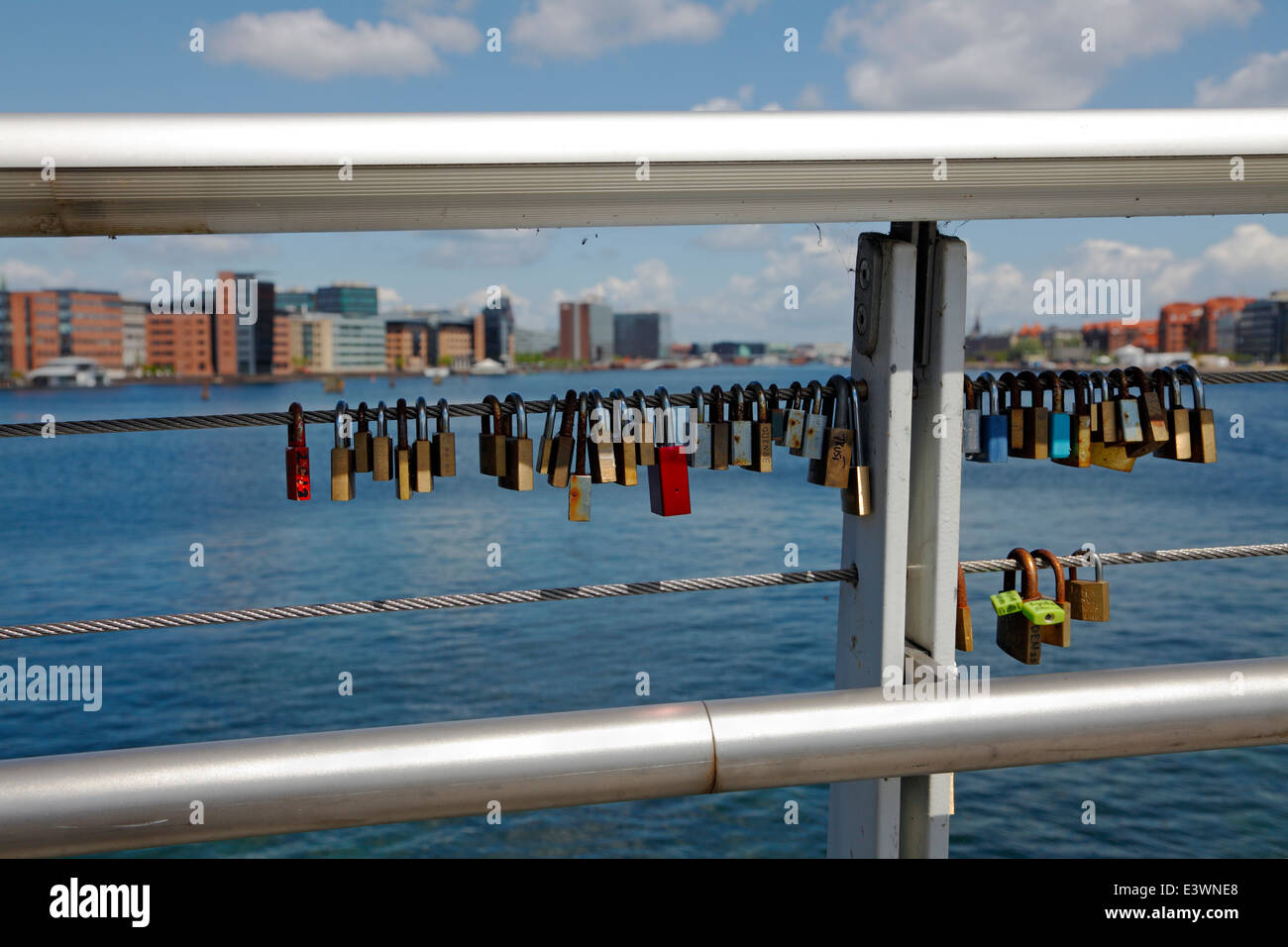 Love locks on the combined bicycle and walkway steel bridge, Bryggebroen, over the southern part of the port of Copenhagen. Denmark. Stock Photo