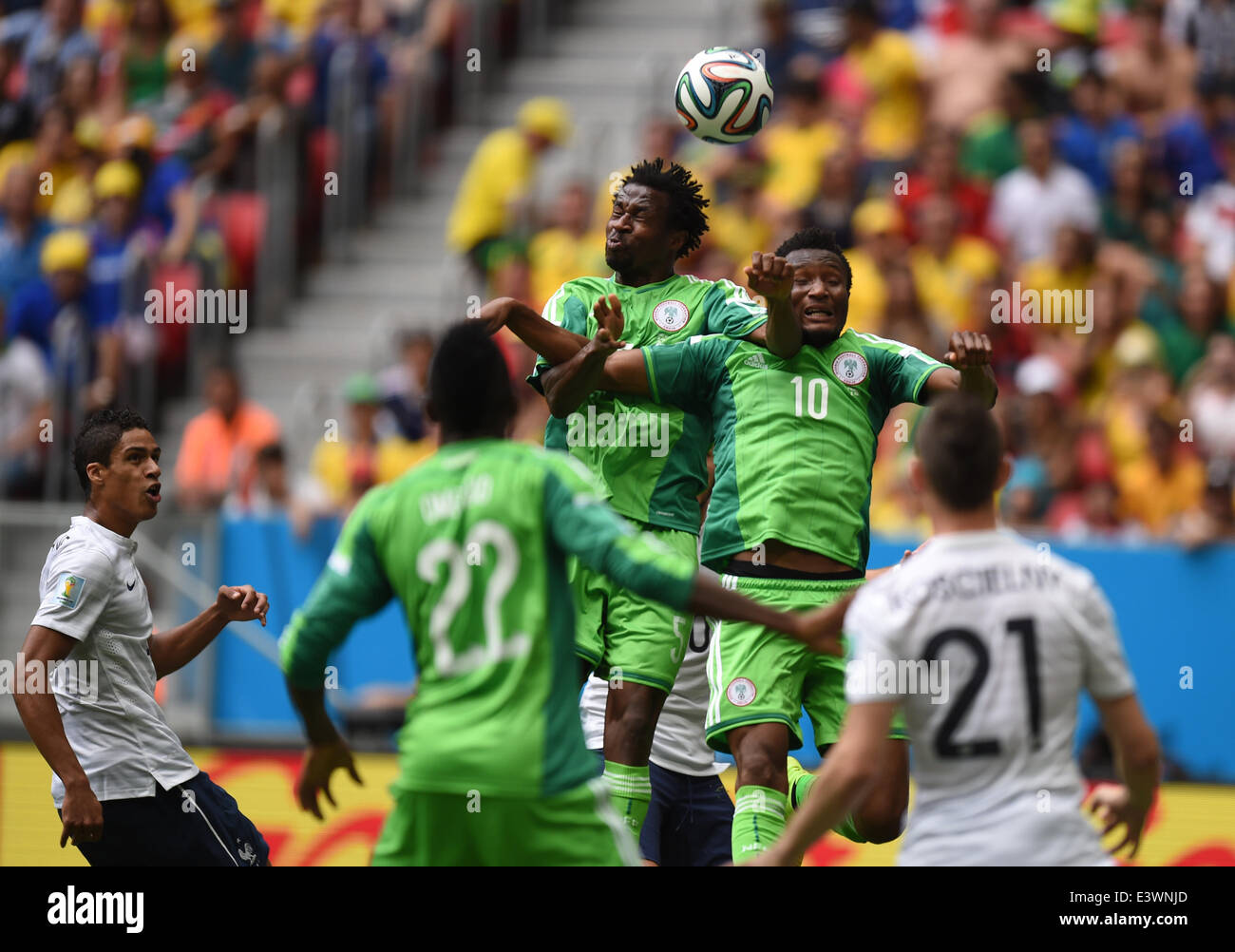 Brasilia, Brazil. 30th June, 2014. Efe Ambrose (C-L) and John Obi Mikel (C-R) of Nigeria go up for a header during the FIFA World Cup 2014 round of 16 match between France and Nigeria at the Estadio National Stadium in Brasilia, Brazil, on 30 June 2014. Credit:  dpa picture alliance/Alamy Live News Stock Photo