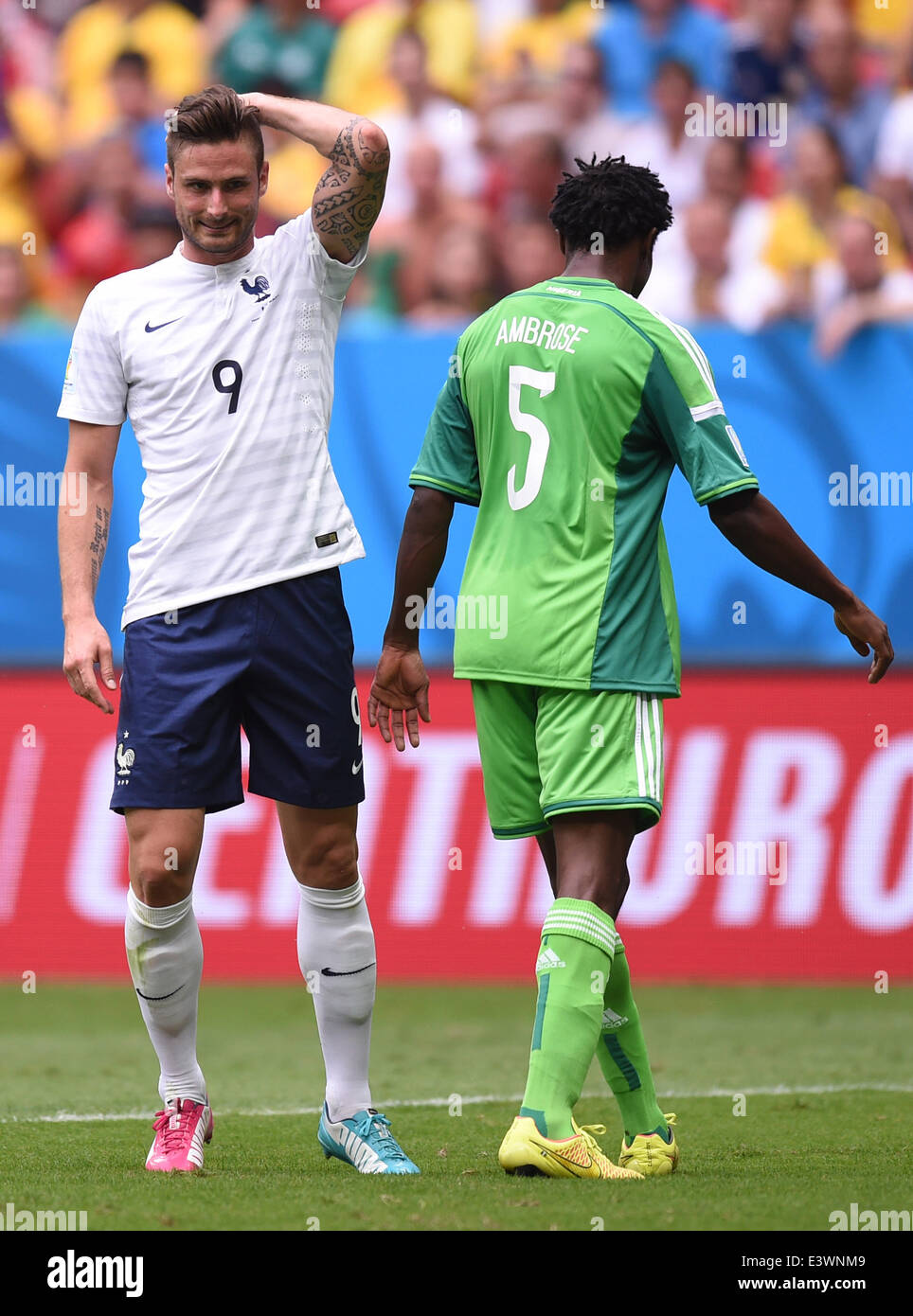 Brasilia, Brazil. 30th June, 2014. Olivier Giroud (L) of France reacts next to Efe Ambrose of Nigeria during the FIFA World Cup 2014 round of 16 match between France and Nigeria at the Estadio National Stadium in Brasilia, Brazil, on 30 June 2014. Credit:  dpa picture alliance/Alamy Live News Stock Photo