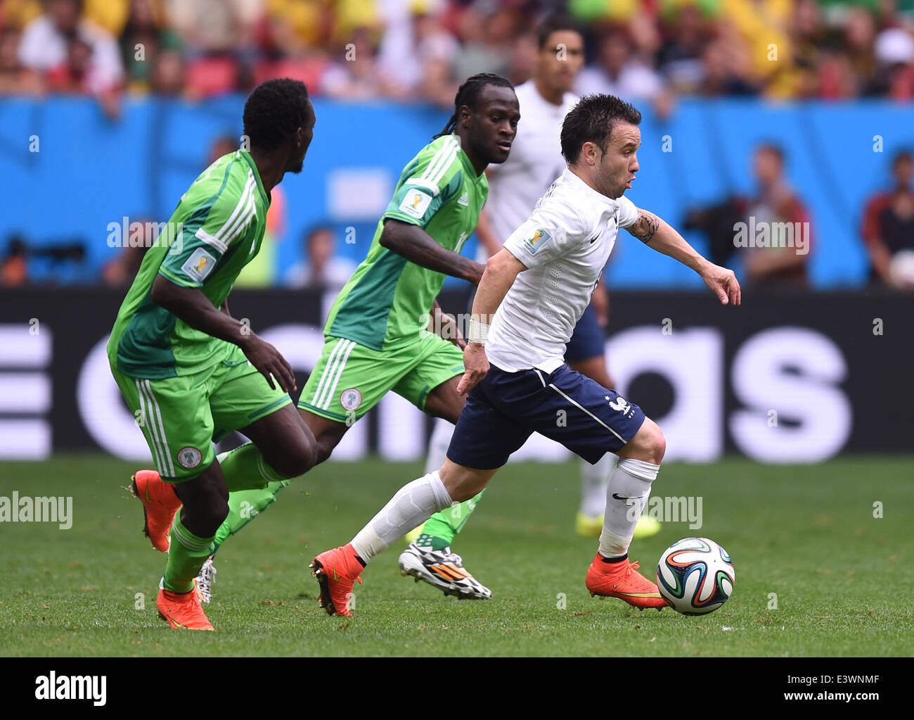 Brasilia, Brazil. 30th June, 2014. Mathieu Valbuena (R) of France in action against Victor Moses (C) of Nigeria during the FIFA World Cup 2014 round of 16 match between France and Nigeria at the Estadio National Stadium in Brasilia, Brazil, on 30 June 2014. Credit:  dpa picture alliance/Alamy Live News Stock Photo
