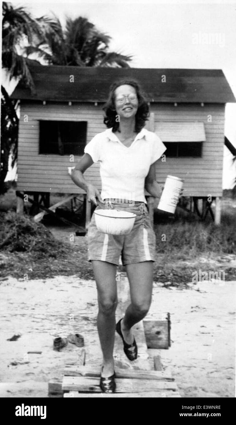 Eva Gibson with mosquito powder and pot near cottage - Big Pine Key Stock Photo