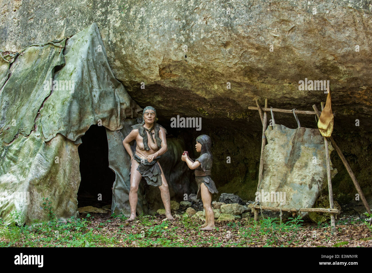 Semi-nomadic Neanderthals in camp with shelter made of animal skins under  overhang in rock face, Prehisto Parc, Tursac, France Stock Photo - Alamy