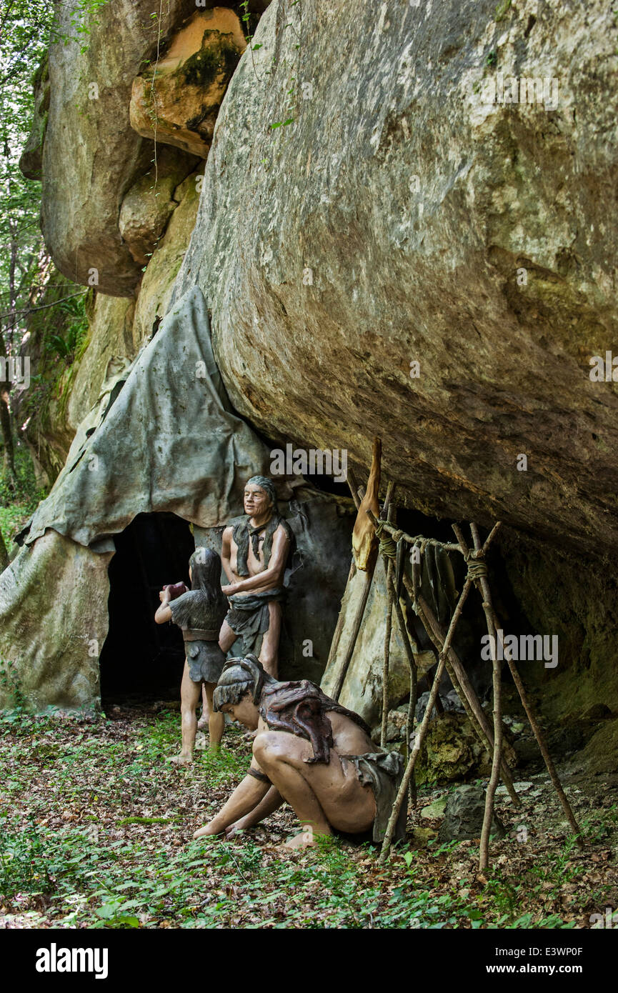 Semi-nomadic Neanderthals in camp with shelter made of animal skins under  overhang in rock face, Prehisto Parc, Tursac, France Stock Photo - Alamy
