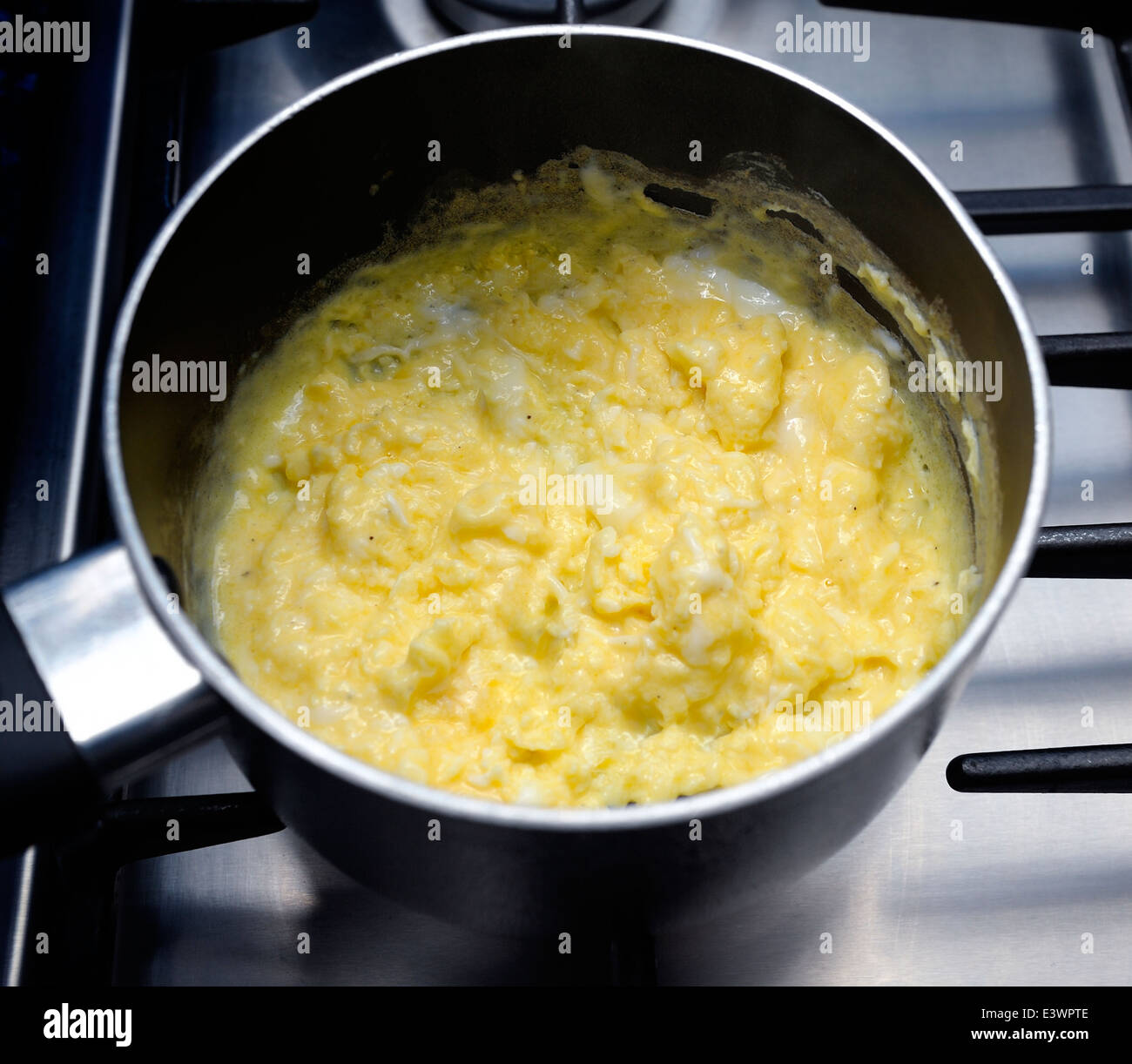 Cooking scrambled eggs in a pan Stock Photo Alamy