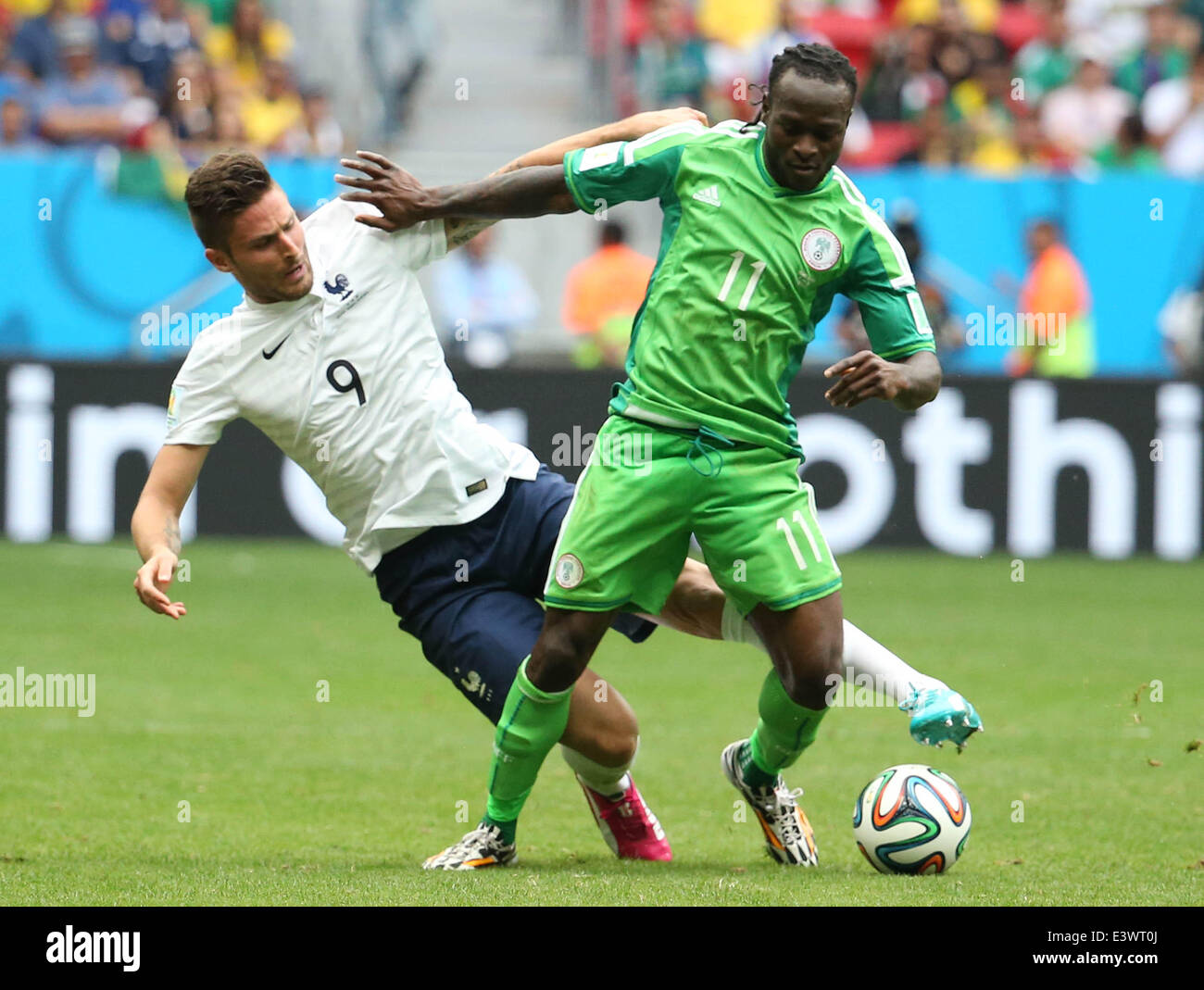 Brasilia, Brazil. 30th June, 2014. France's Olivier Giroud (L) vies with Nigeria's Victor Moses during a Round of 16 match between France and Nigeria of 2014 FIFA World Cup at the Estadio Nacional Stadium in Brasilia, Brazil, on June 30, 2014. Credit:  Xinhua/Alamy Live News Stock Photo