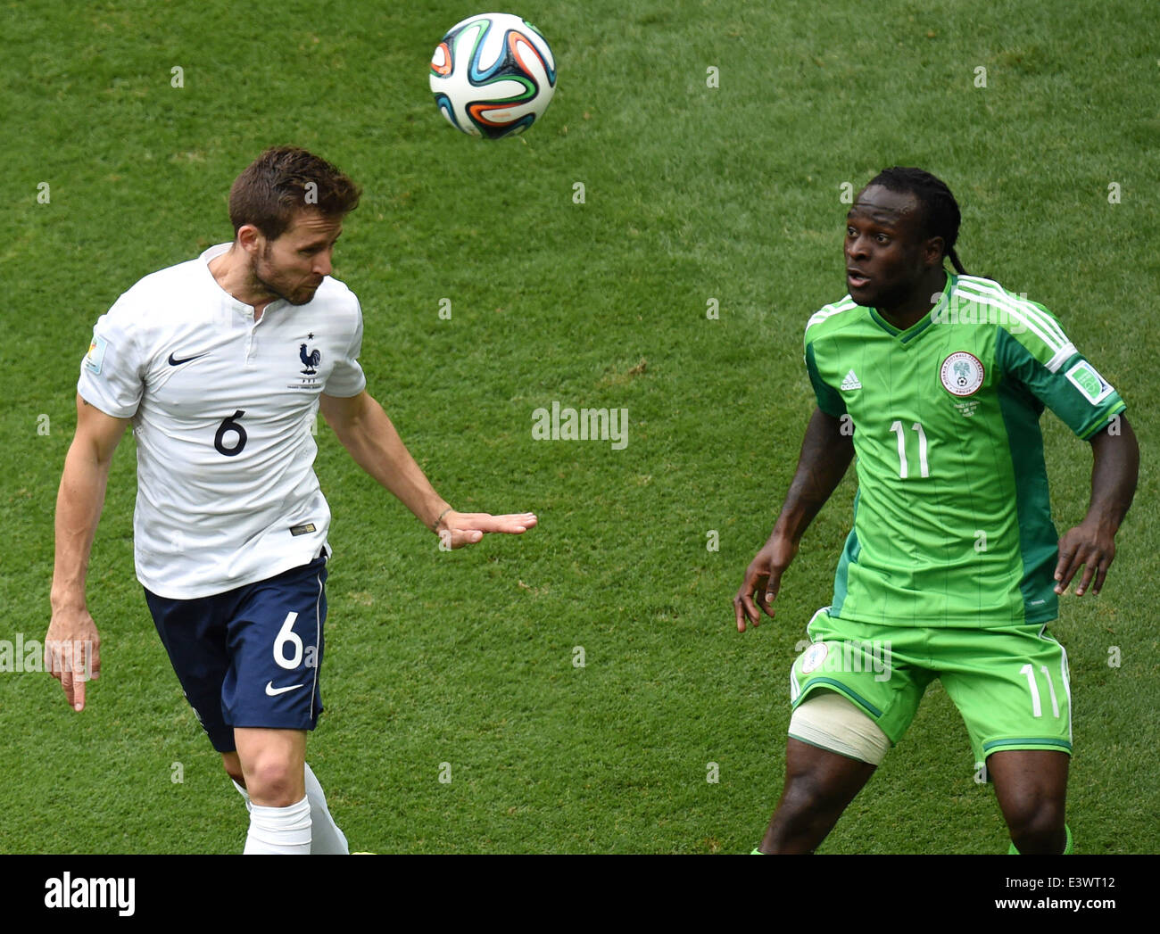 Brasilia, Brazil. 30th June, 2014. France's Yohan Cabaye (L) vies with Nigeria's Victor Moses during a Round of 16 match between France and Nigeria of 2014 FIFA World Cup at the Estadio Nacional Stadium in Brasilia, Brazil, on June 30, 2014.  Credit:  Xinhua/Alamy Live News Stock Photo