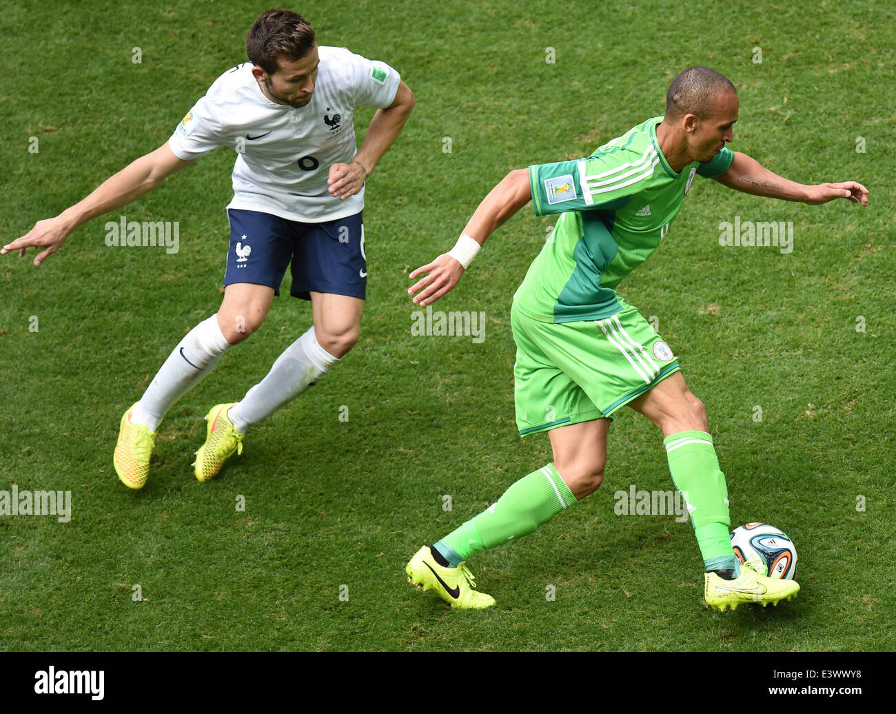 Brasilia, Brazil. 30th June, 2014. France's Yohan Cabaye (L) vies with Nigeria's Peter Osaze Odemwingie during a Round of 16 match between France and Nigeria of 2014 FIFA World Cup at the Estadio Nacional Stadium in Brasilia, Brazil, on June 30, 2014. France won 2-0 over Nigeria and qualified for Quarter-finals here on Monday. Credit:  Liu Dawei/Xinhua/Alamy Live News Stock Photo