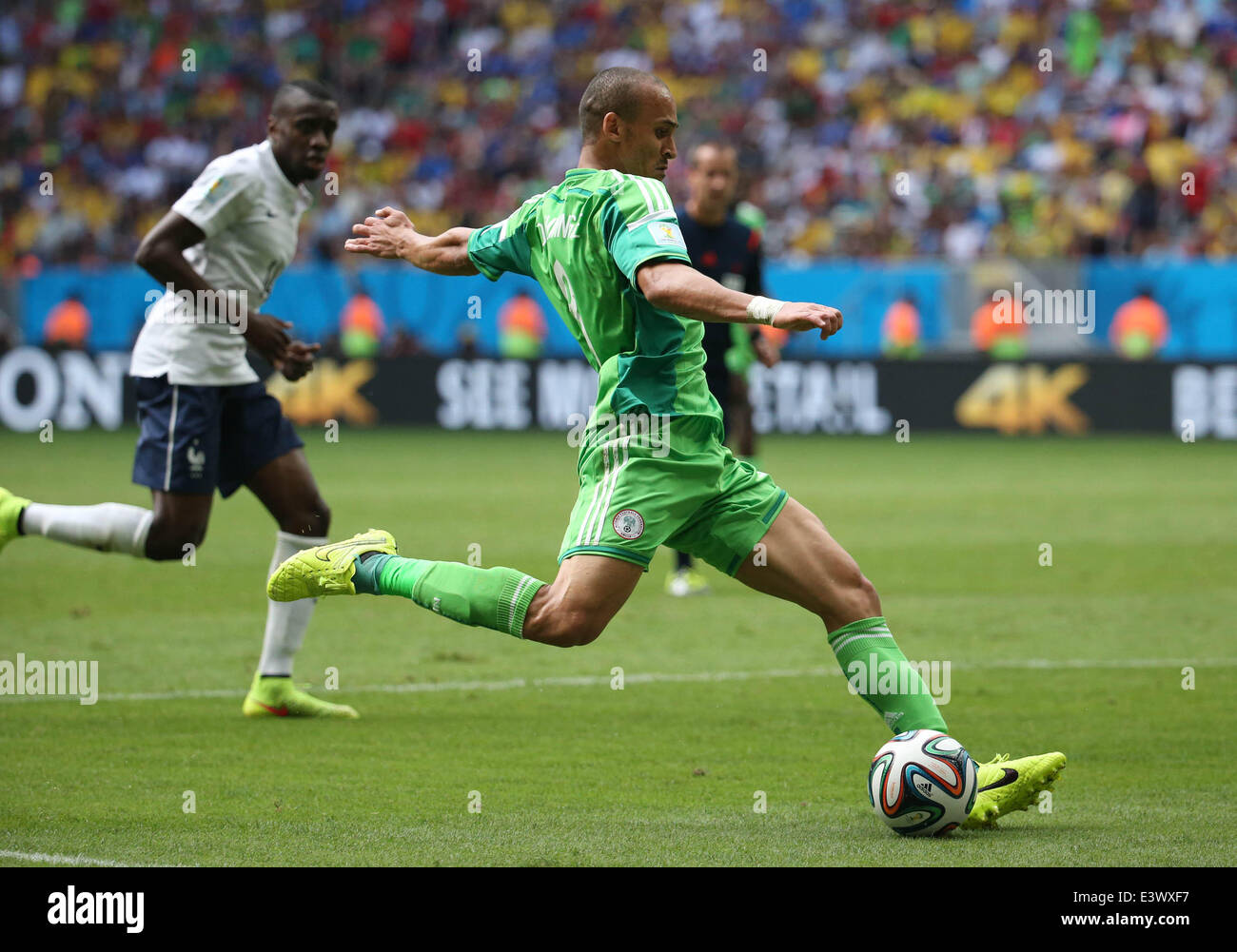 Brasilia, Brazil. 30th June, 2014. Nigeria's Peter Osaze Odemwingie (front) shoots during a Round of 16 match between France and Nigeria of 2014 FIFA World Cup at the Estadio Nacional Stadium in Brasilia, Brazil, on June 30, 2014. France won 2-0 over Nigeria and qualified for Quarter-finals here on Monday. Credit:  Li Ming/Xinhua/Alamy Live News Stock Photo