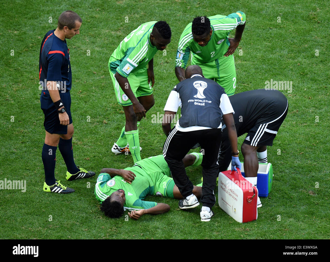 Brasilia, Brazil. 30th June, 2014. Nigeria's Efe Ambrose receives medical treatment during a Round of 16 match between France and Nigeria of 2014 FIFA World Cup at the Estadio Nacional Stadium in Brasilia, Brazil, on June 30, 2014. France won 2-0 over Nigeria and qualified for Quarter-finals here on Monday. Credit:  Liu Dawei/Xinhua/Alamy Live News Stock Photo